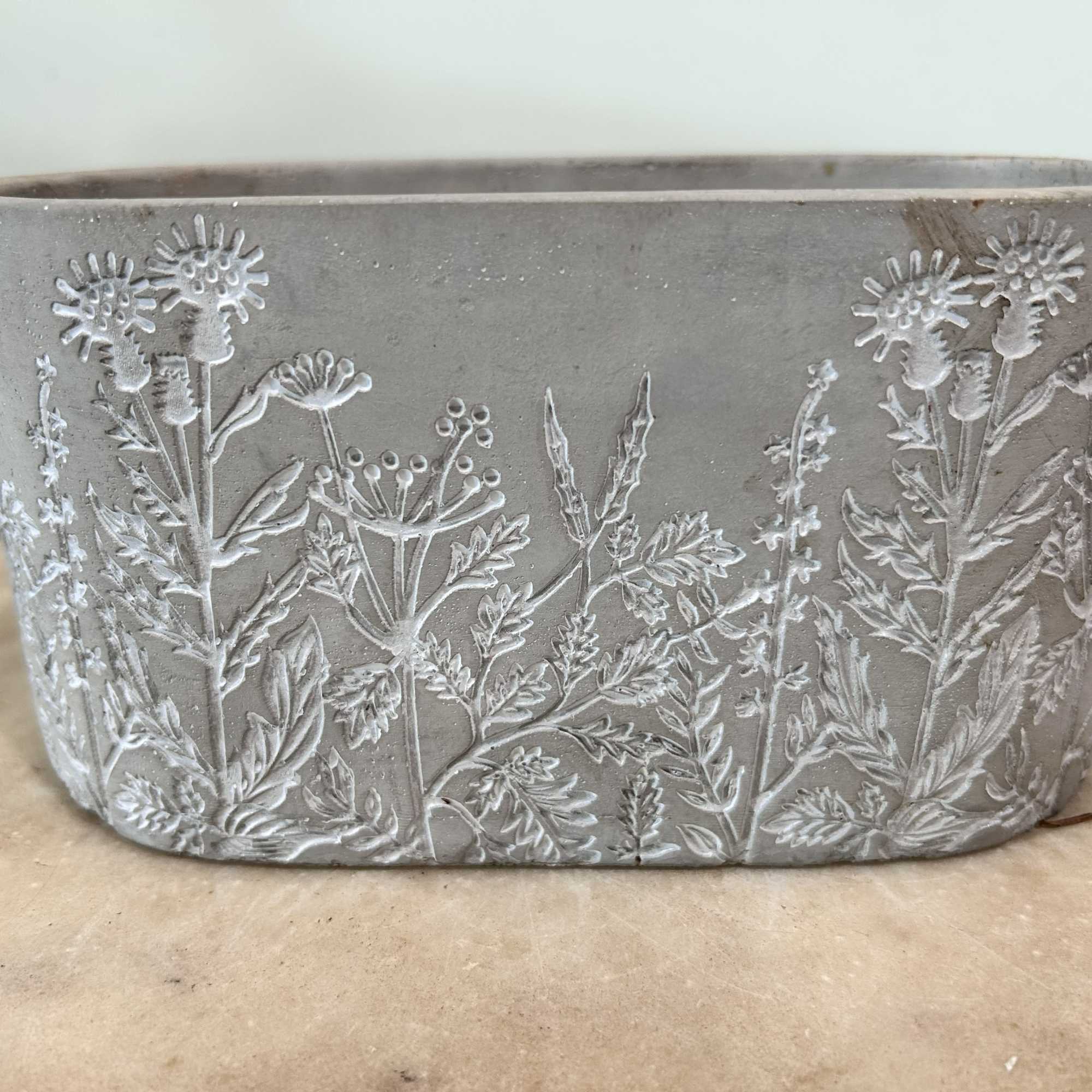 A ceramic basket is used as the base of this arrangement. The