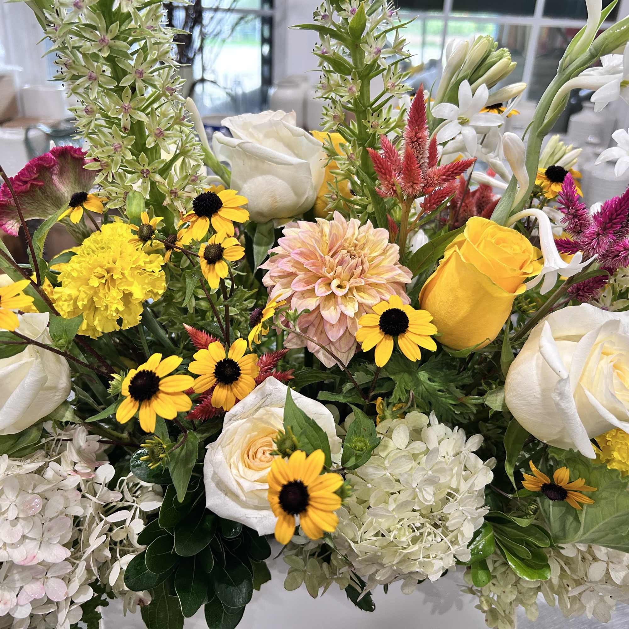 Mixed bouquet with white roses, yellow daisies, and white hydrangeas
