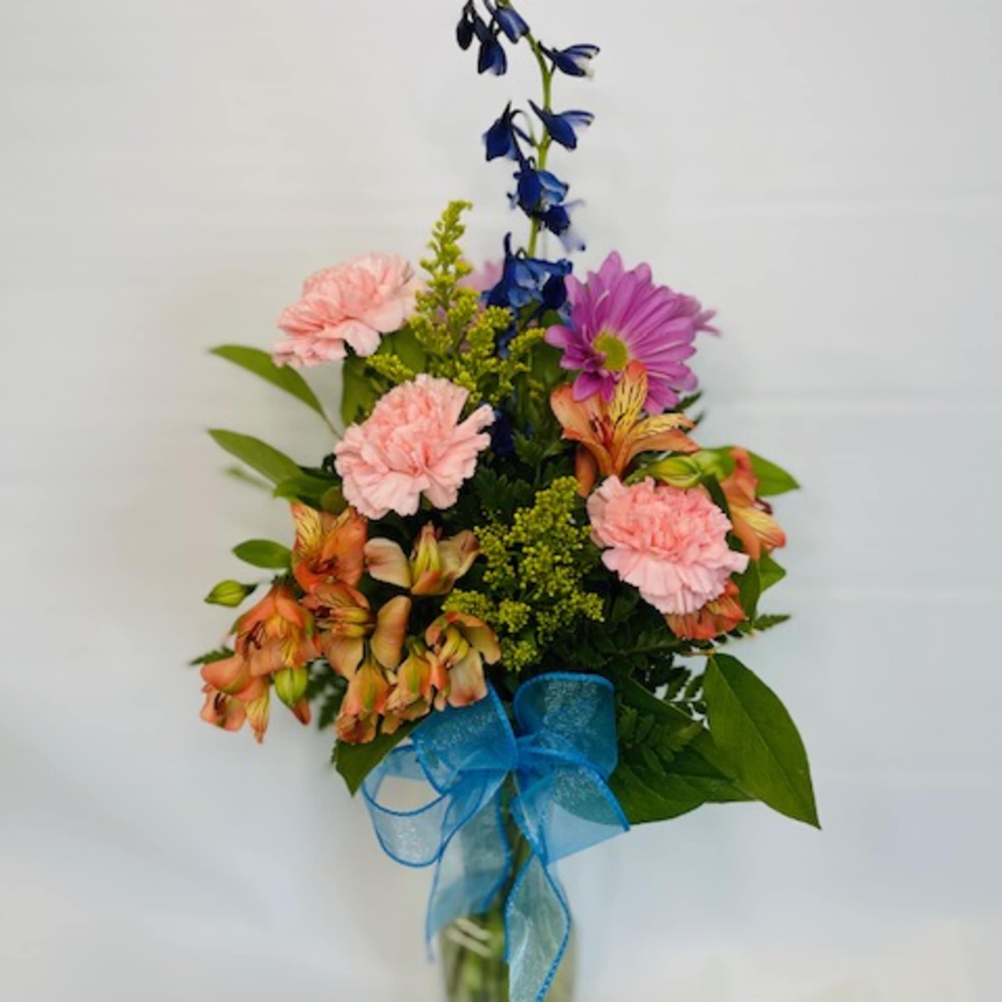 Mixed flowers and colors arranged in a clear vase, photo 2 of 2