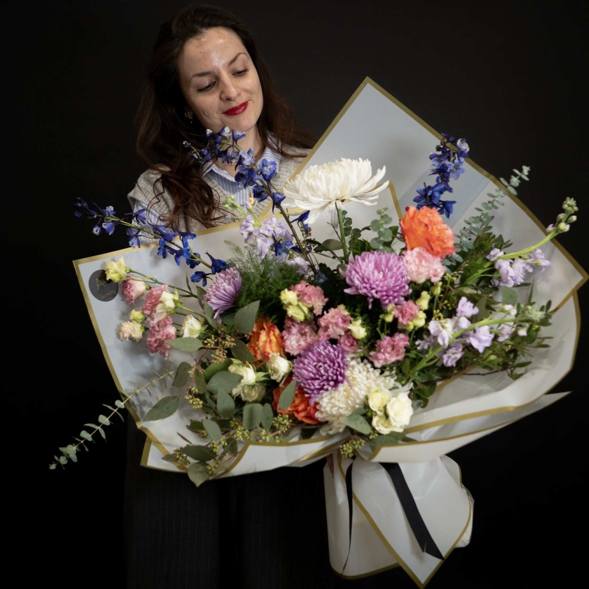 Large mixed bouquet with purple, pink, white, and orange flowers