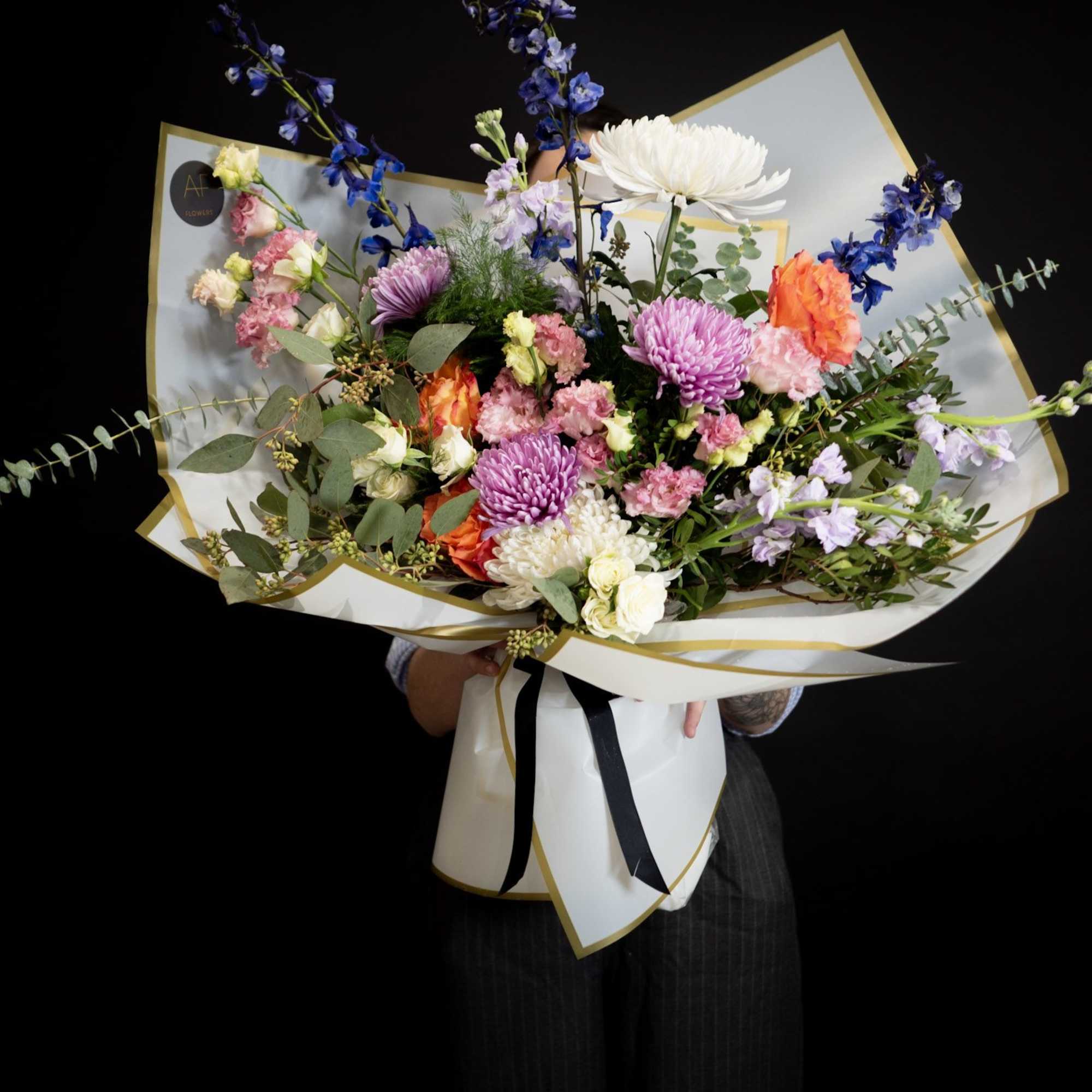 Large mixed bouquet with purple, pink, white, and orange flowers, photo 2 of 3