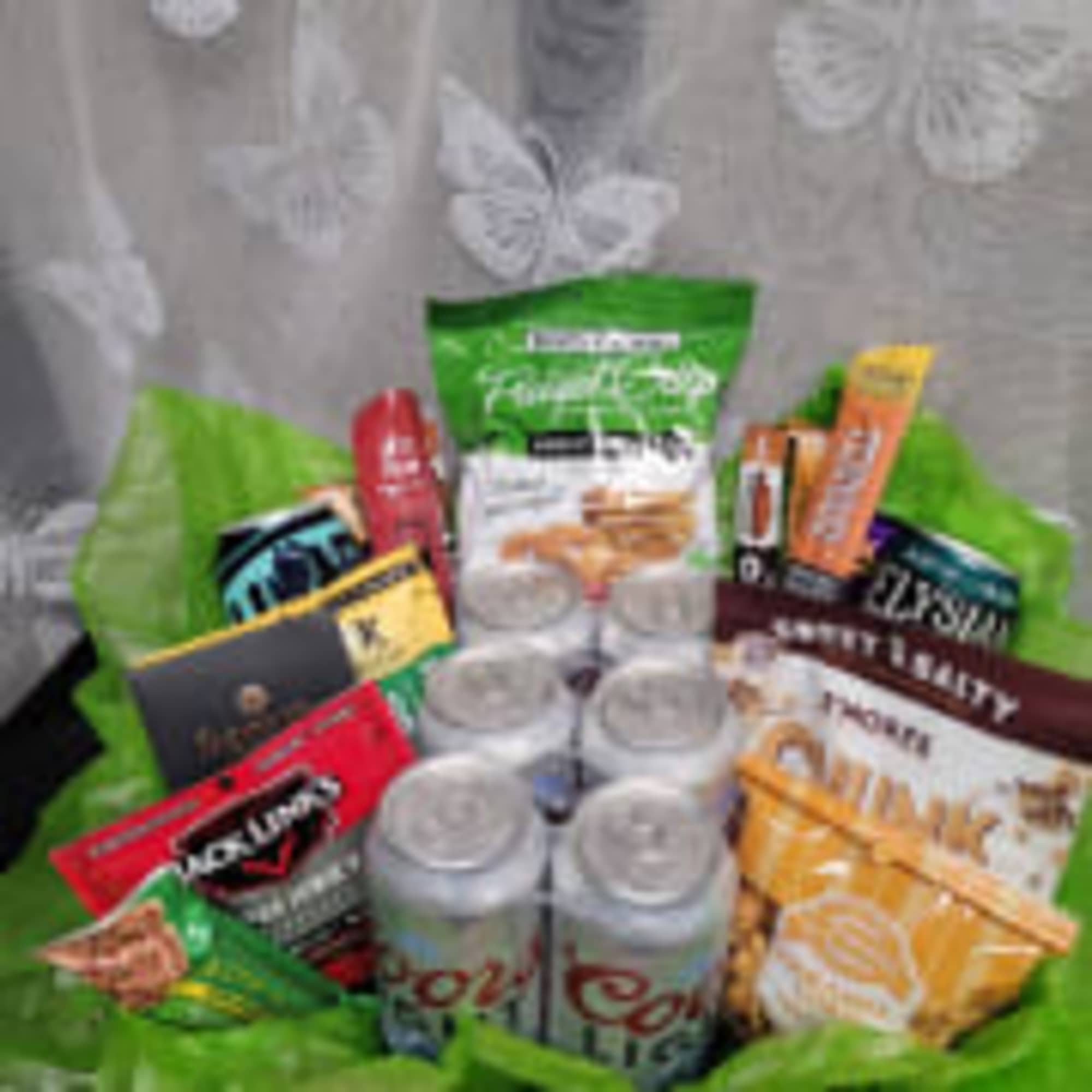 Gift basket with assorted snack packs and soda cans