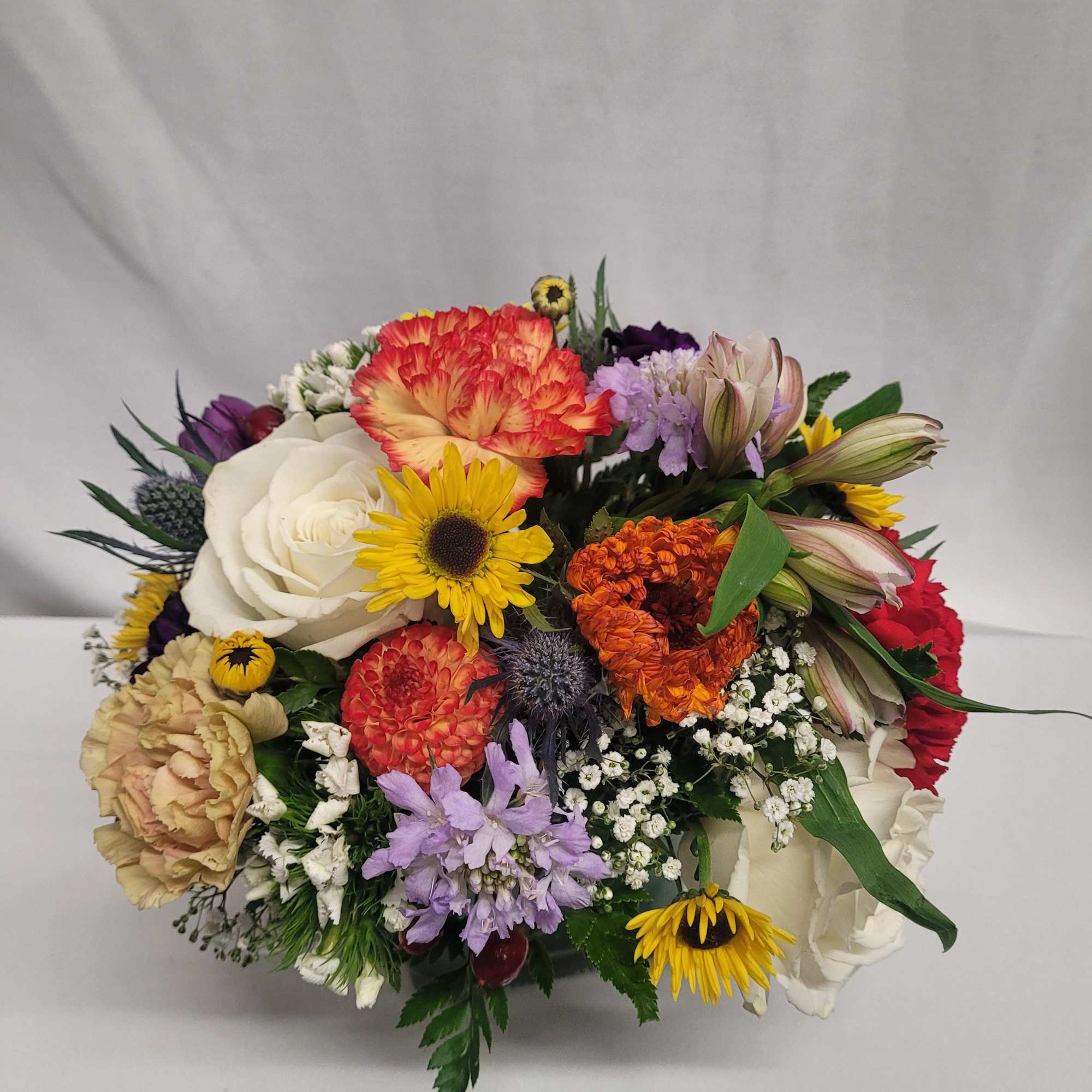 Mixed bouquet with roses, carnations, and daisies in bright colors