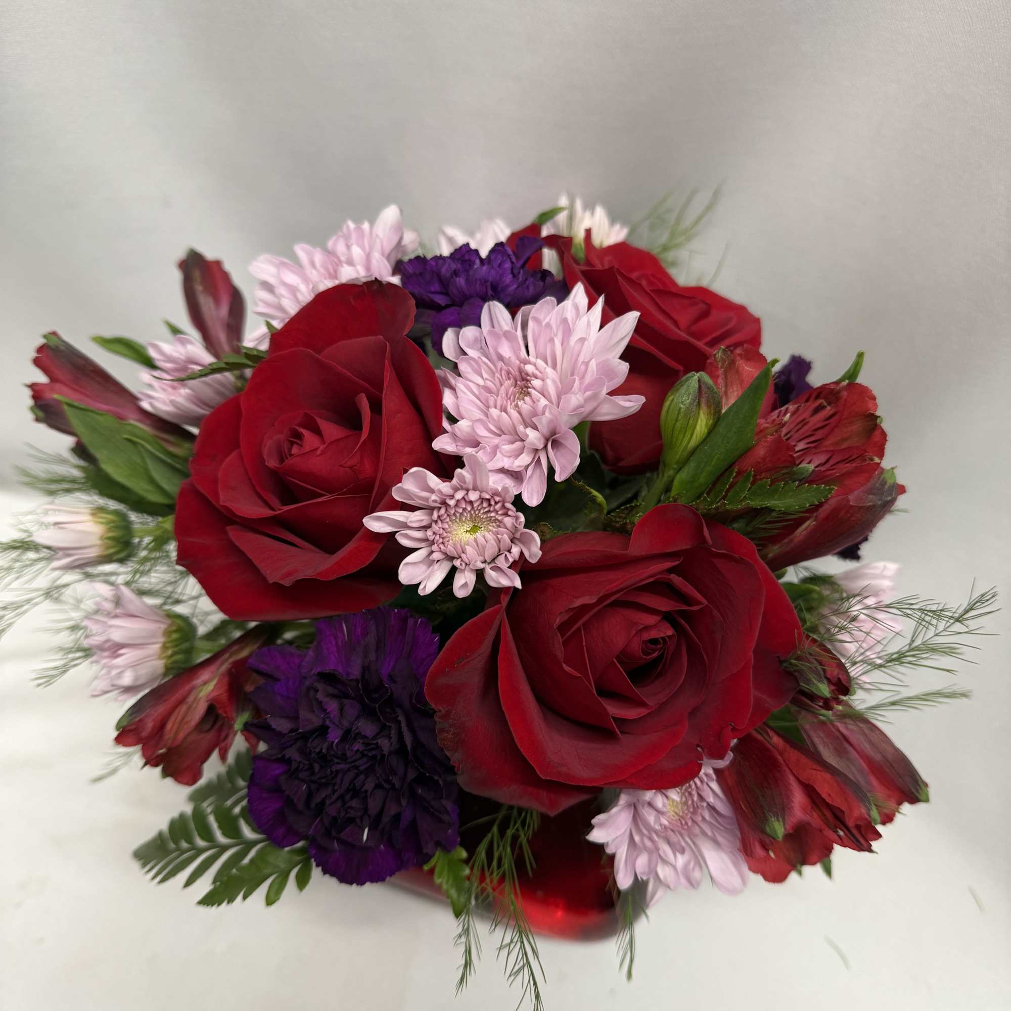 Bouquet of red roses with pink and purple flowers