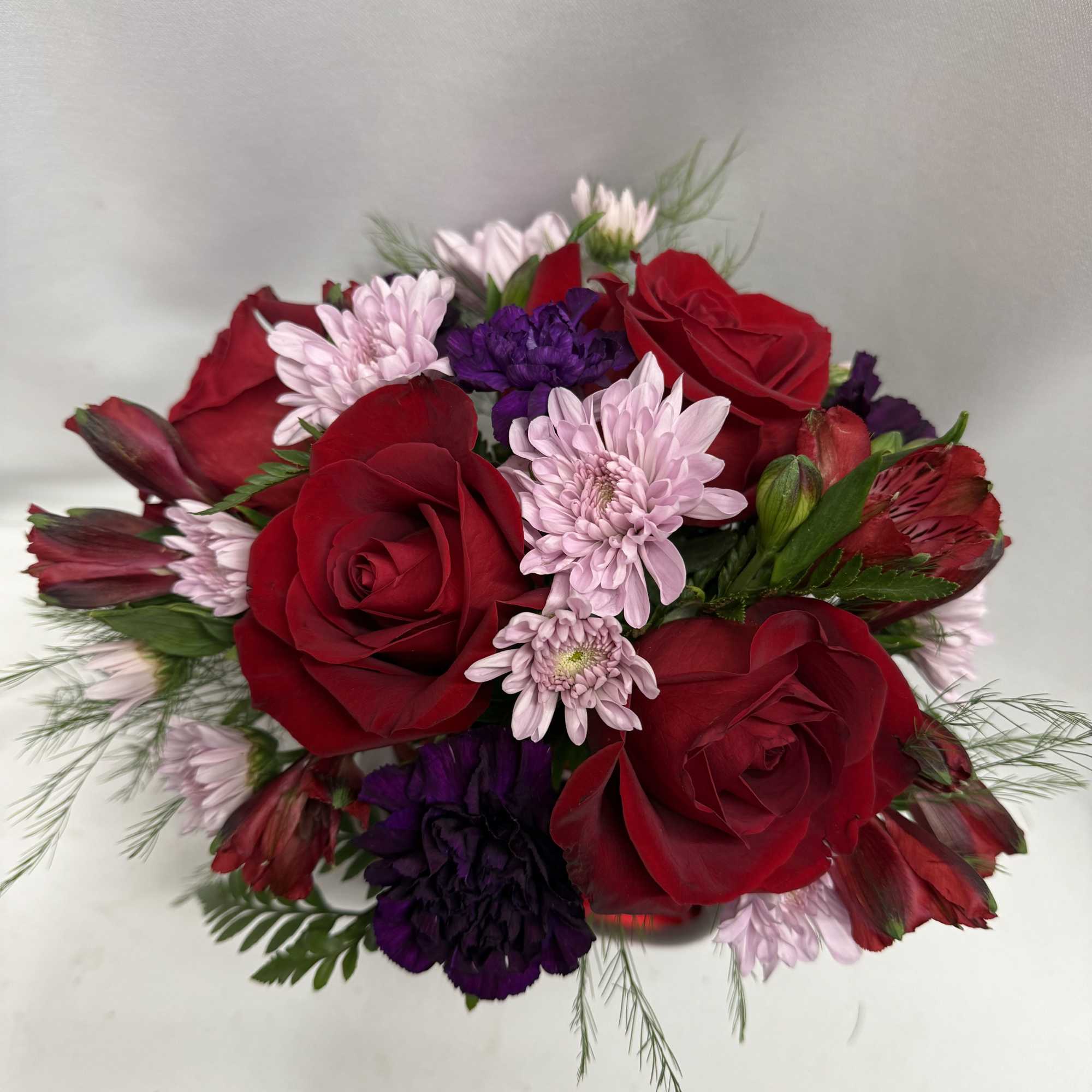 Bouquet of red roses with pink and purple flowers