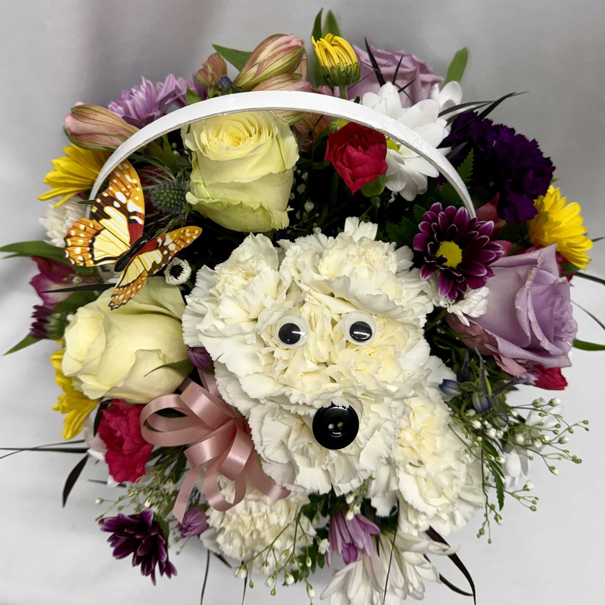 Cute puppy made out of carnations surrounded by seasonal flowers . Great