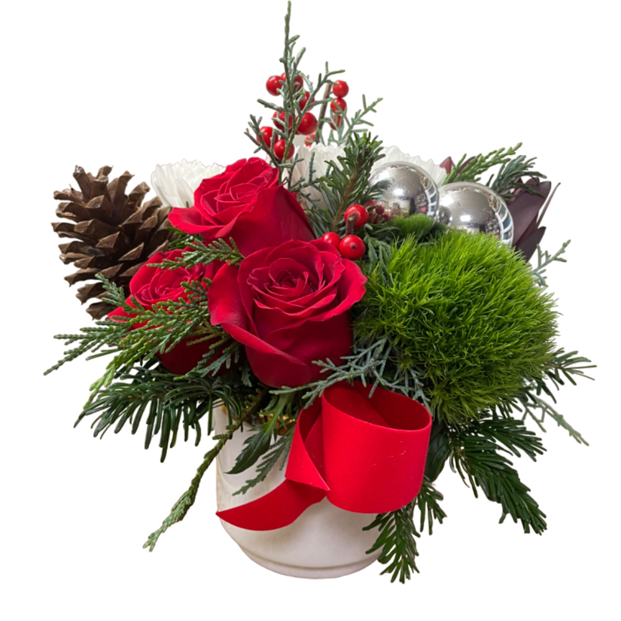 Red roses in a white vase with pinecones and a red ribbon
