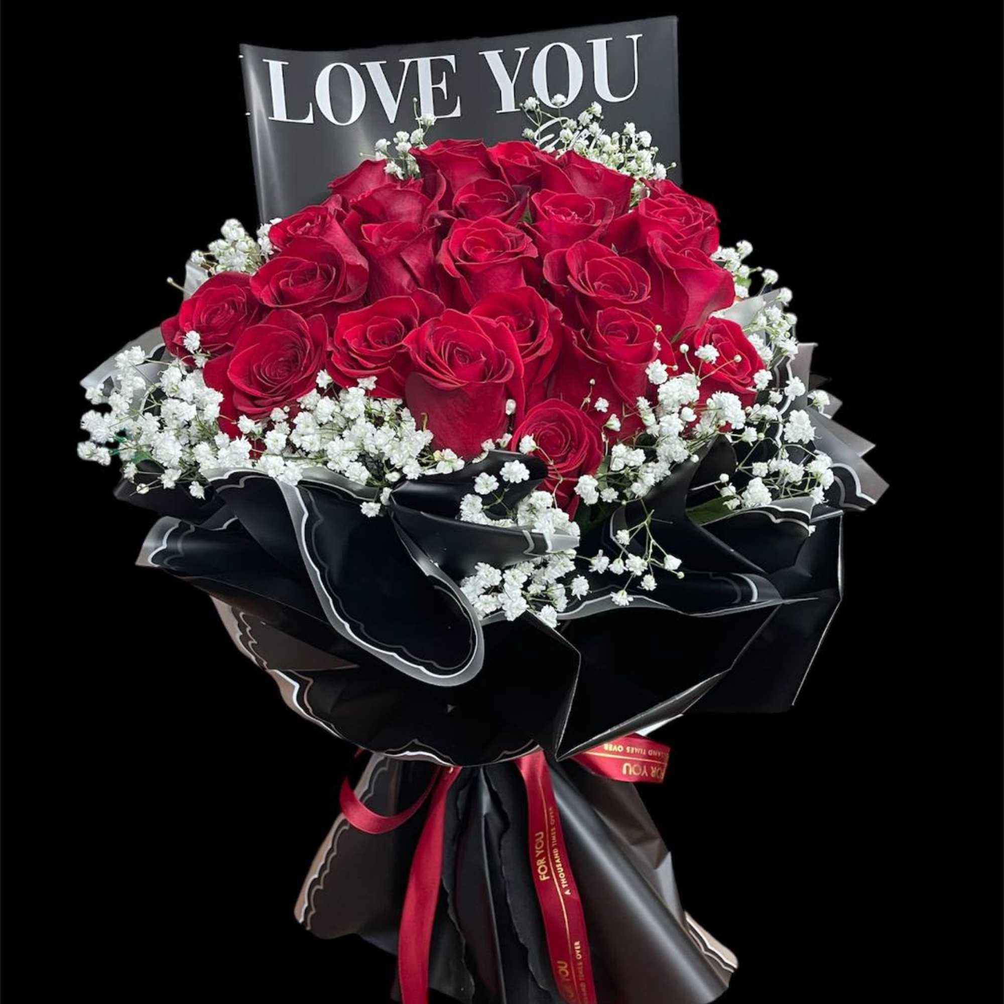 Bouquet of red roses with baby's breath and a LOVE YOU card