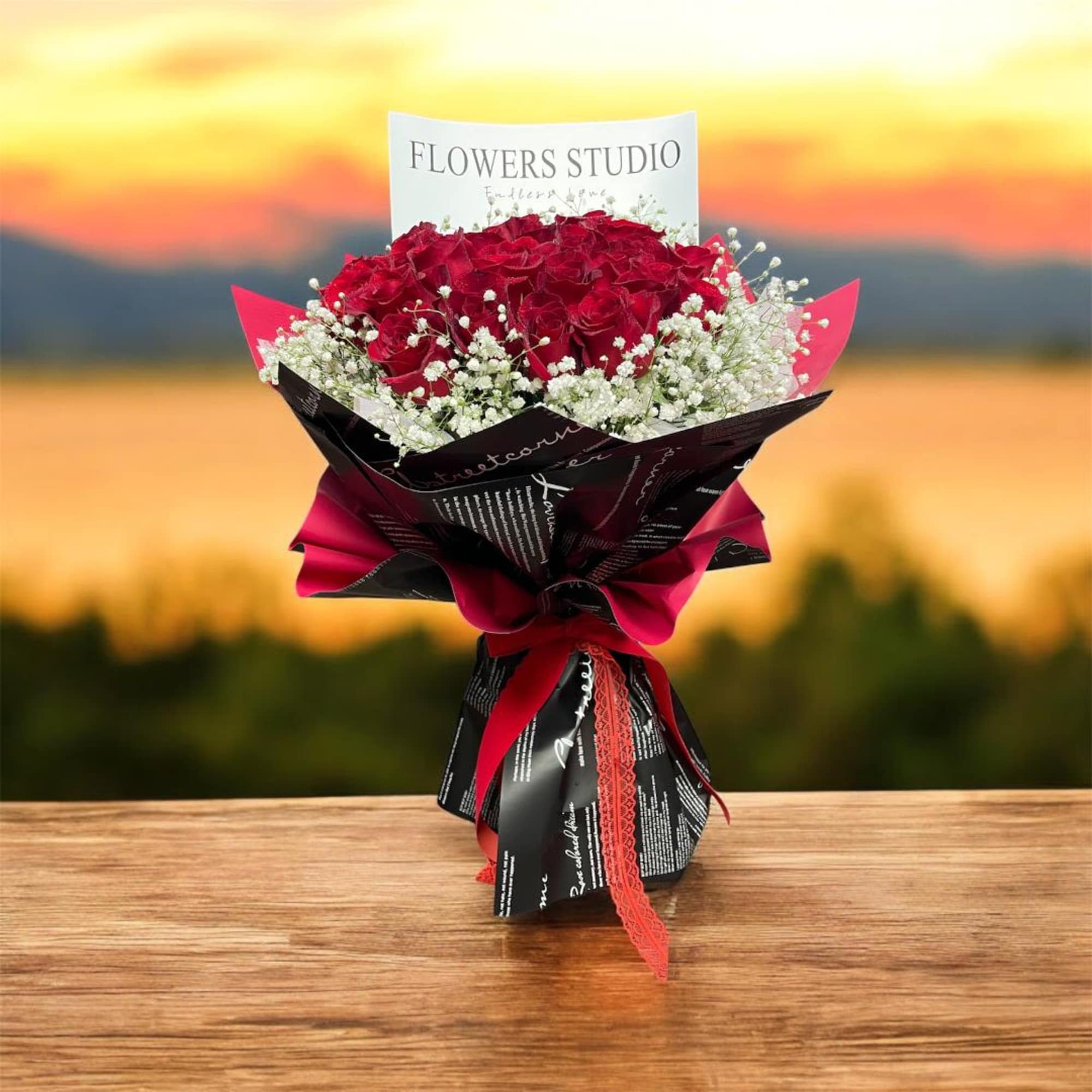 Bouquet of red roses with white baby's breath in black and red wrap
