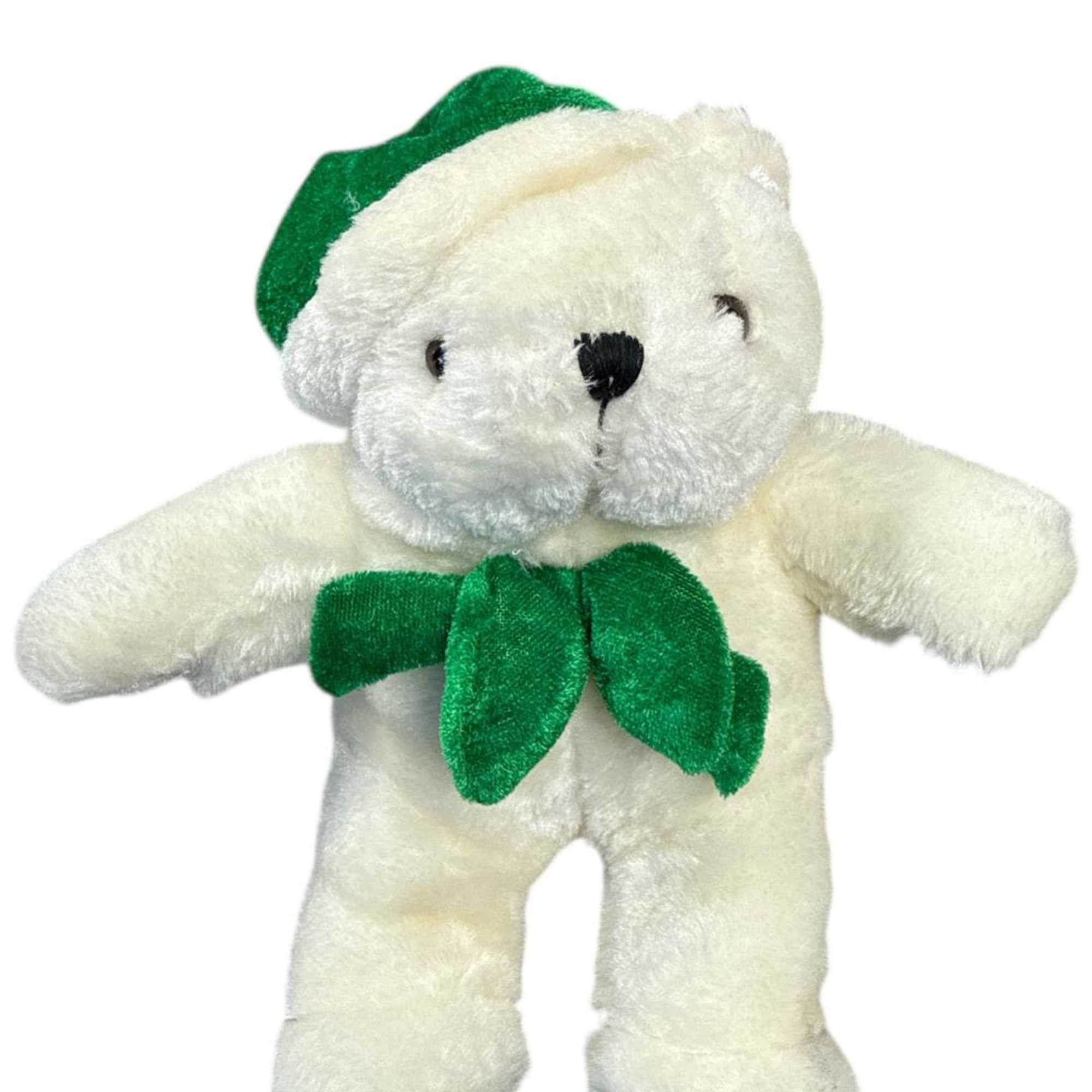 White teddy bear with a green hat and bow