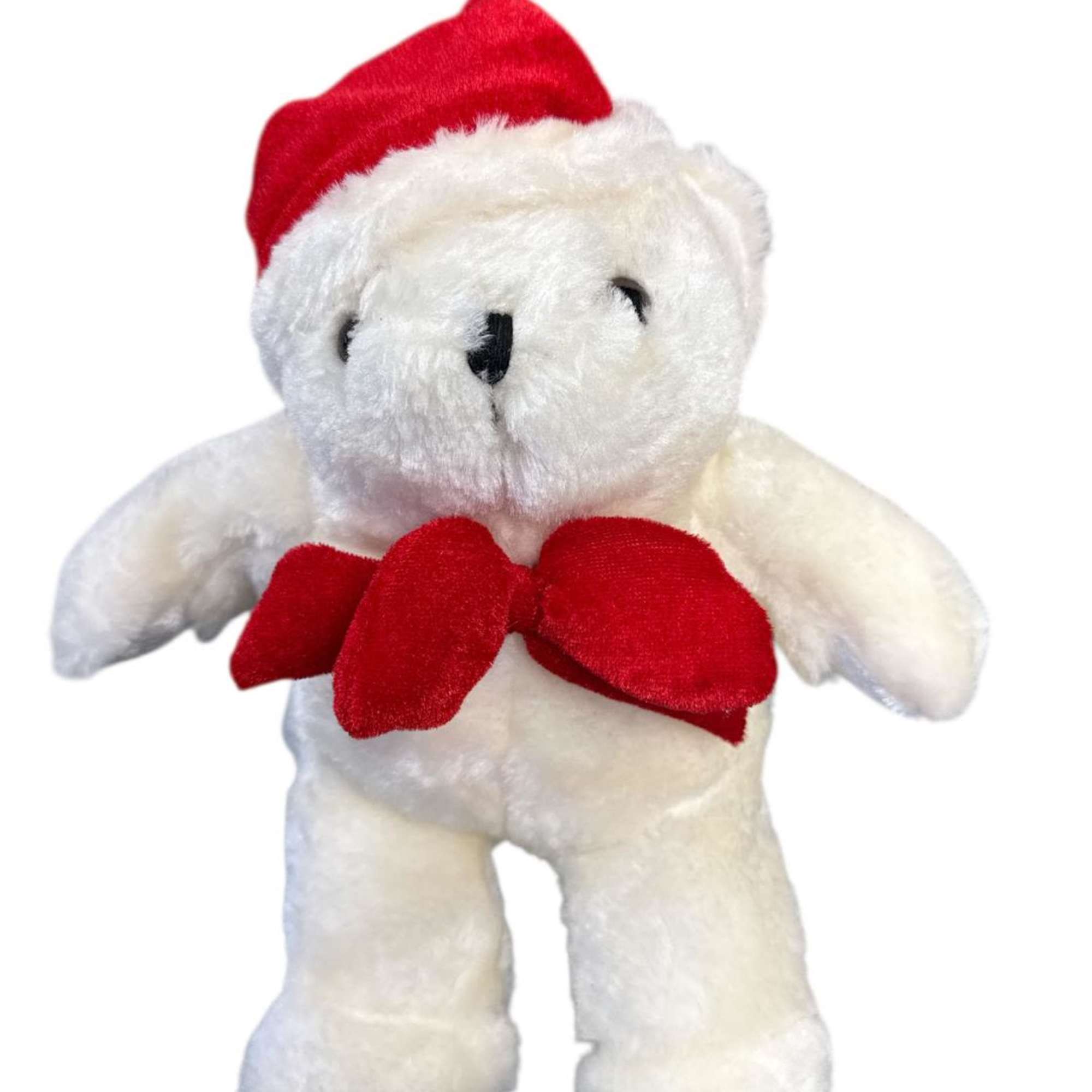 White teddy bear wearing a red Santa hat and bow