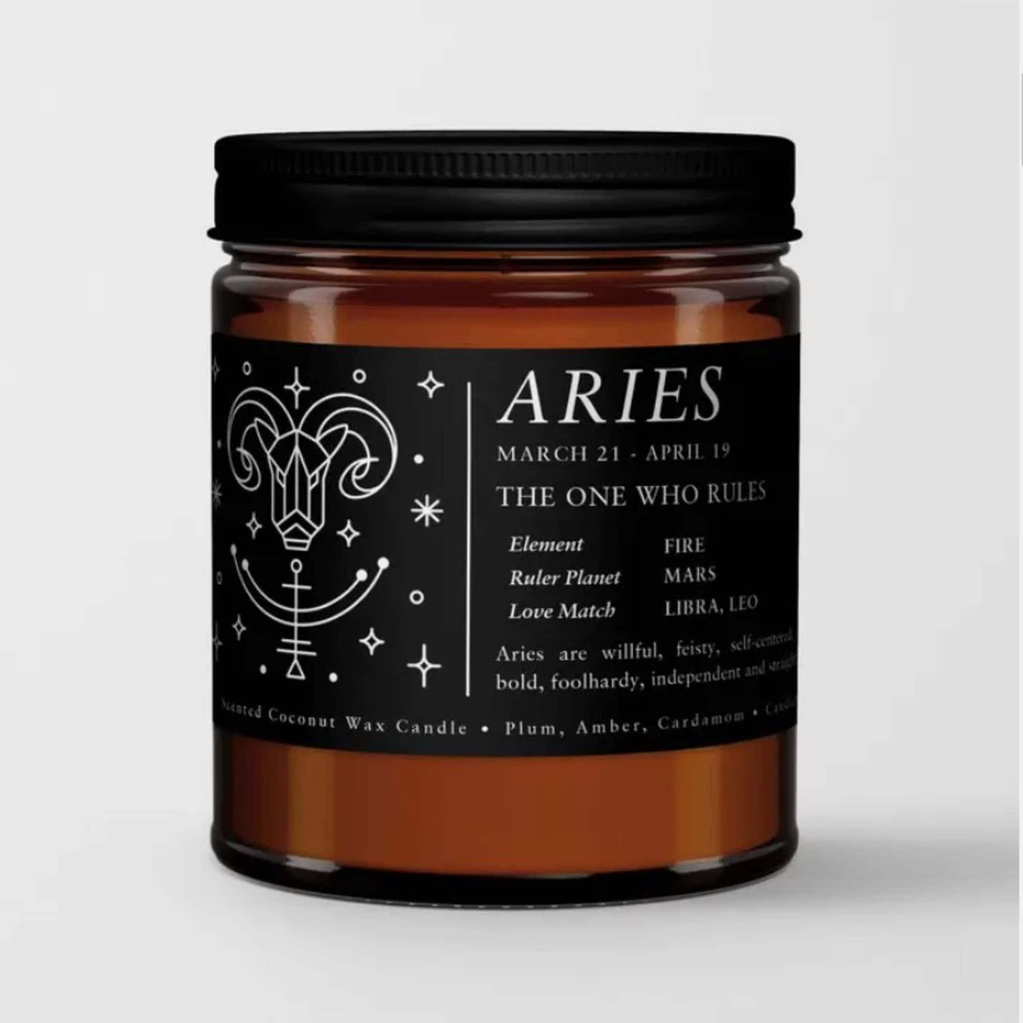 Black-labeled Aries candle in an amber glass jar with a black lid