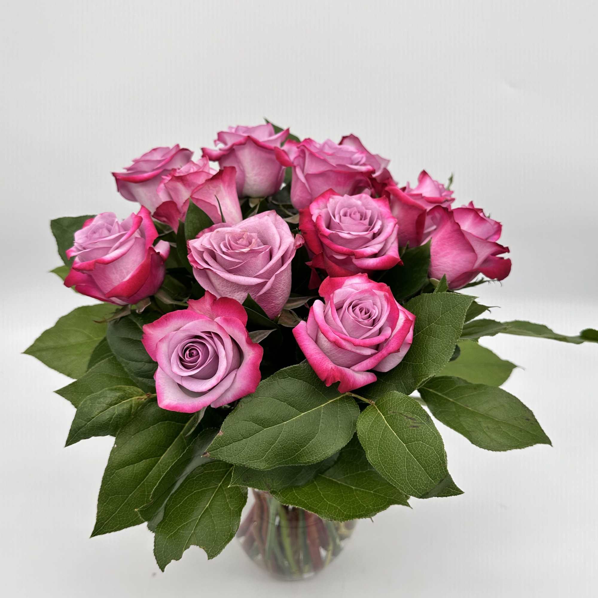 Bouquet of pink roses in a clear glass vase