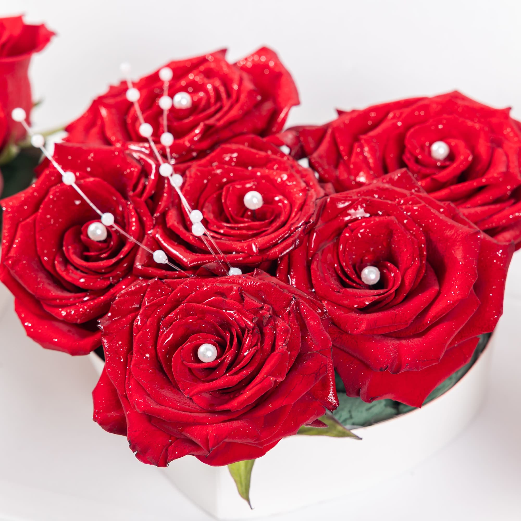 A trio of red rose arrangements in heart, round, and rectangular white, photo 2 of 2