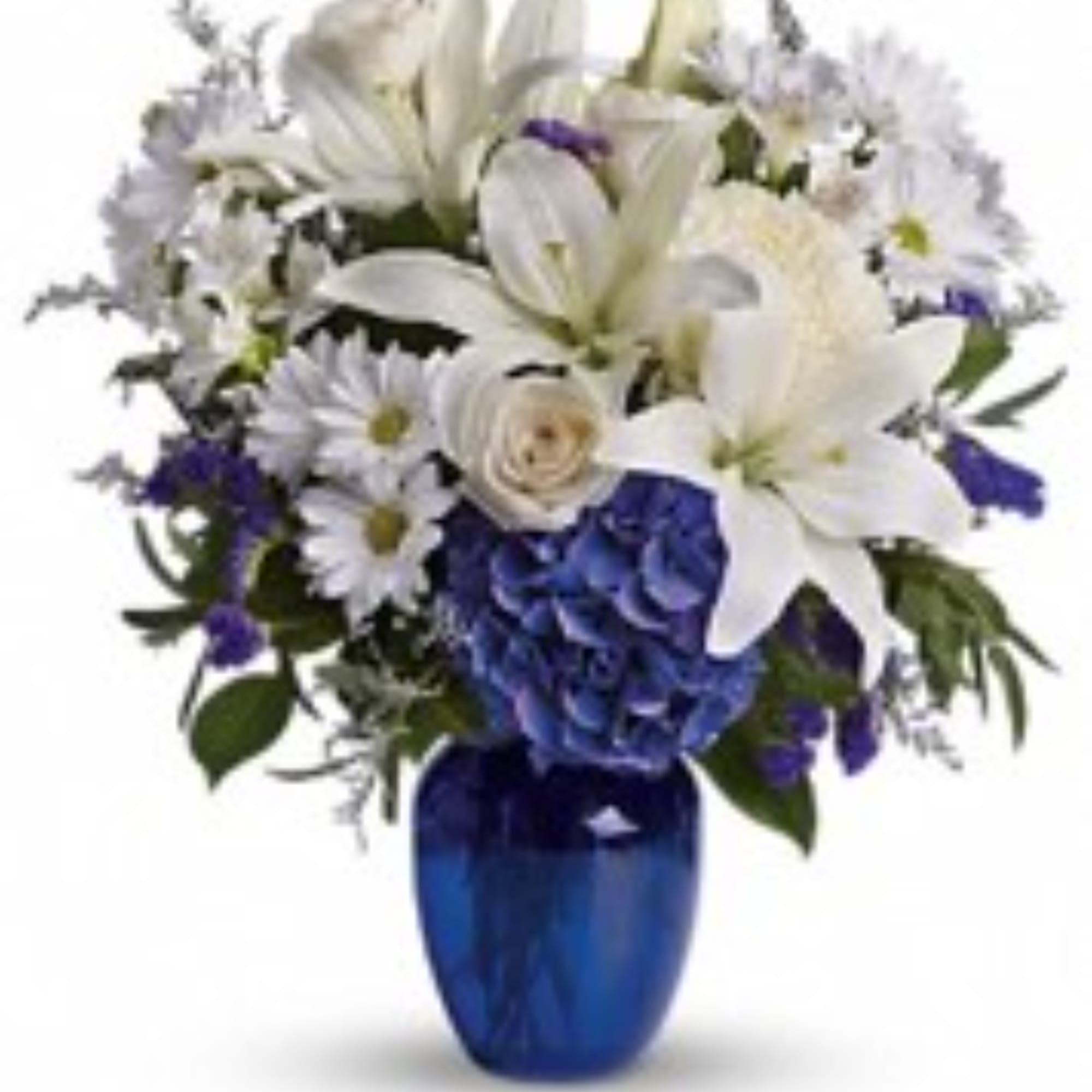 White lilies and daisies with blue flowers in a cobalt vase