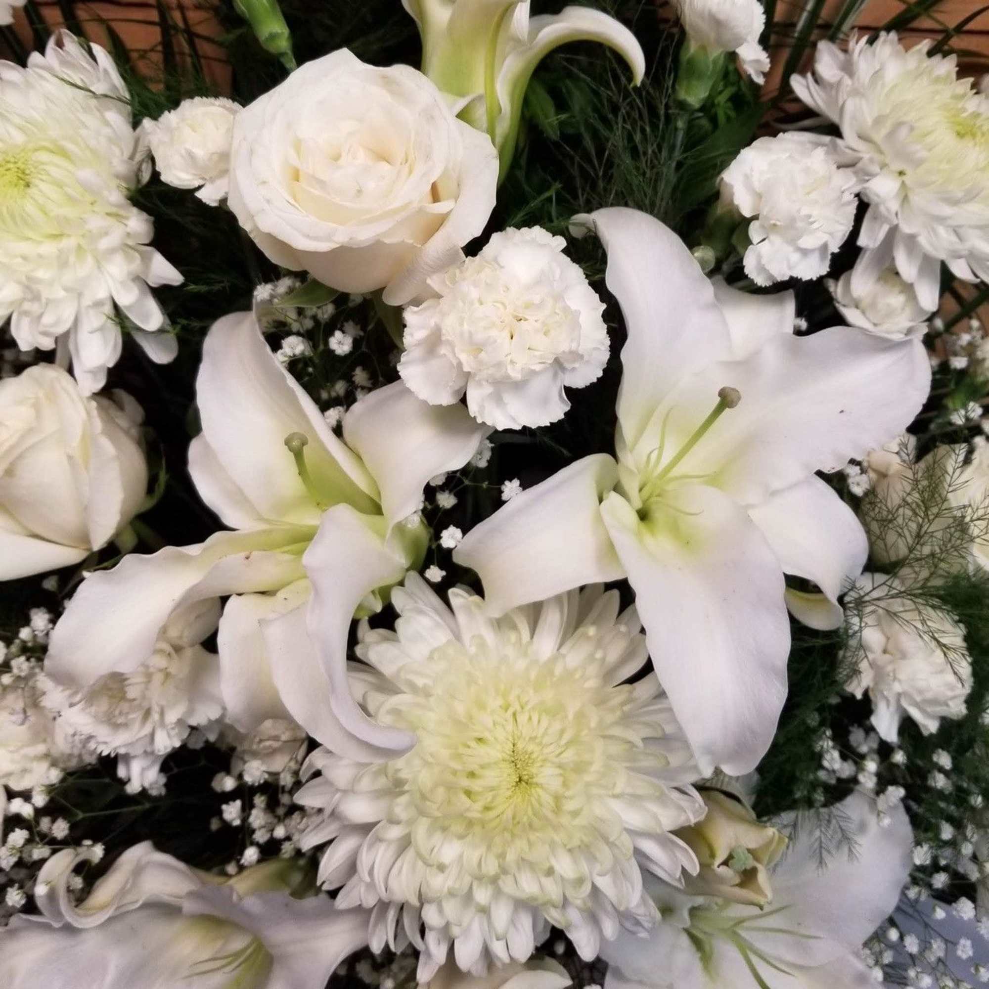 White lilies, roses, and chrysanthemums in a floral arrangement