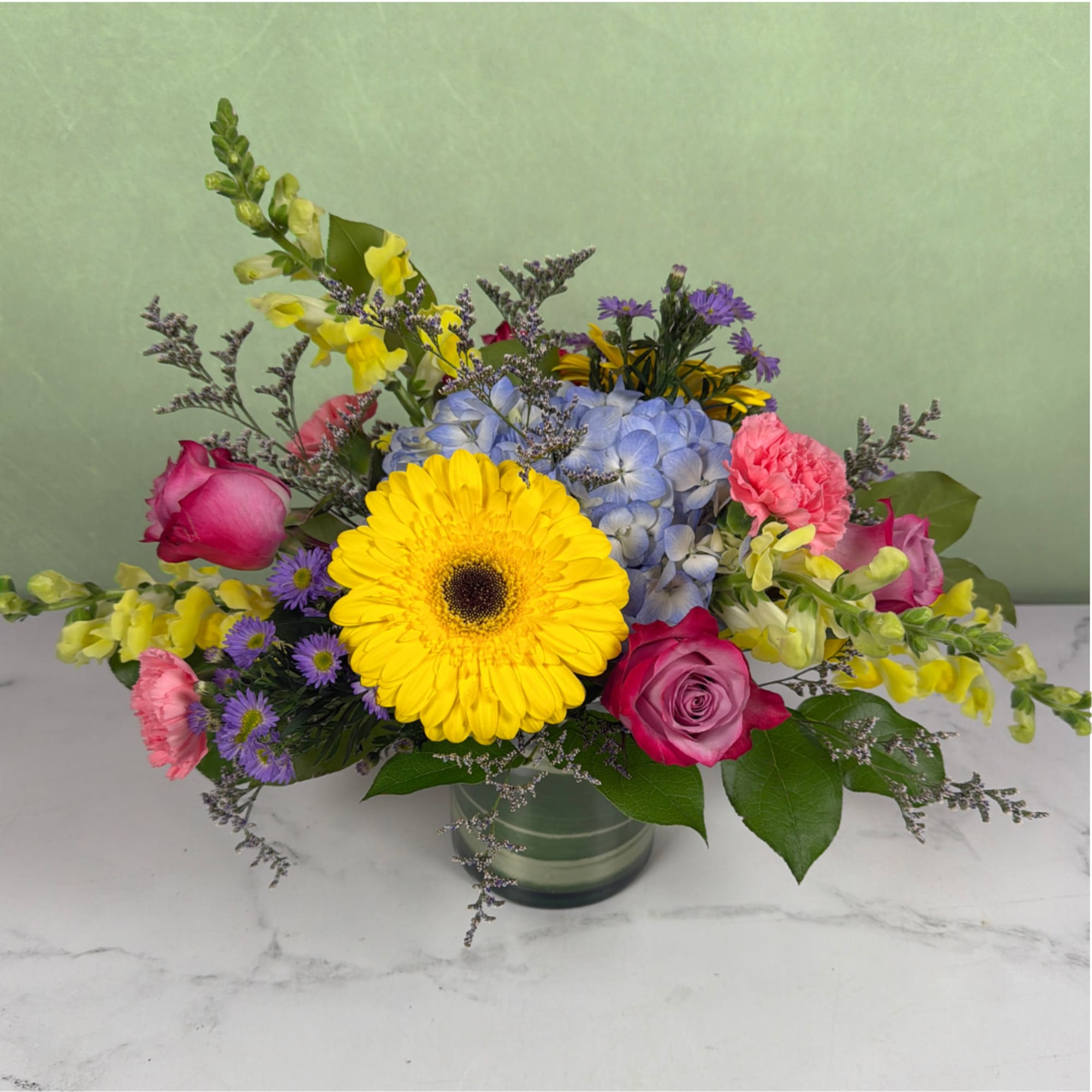 Colorful flowers are blooming in this Breath of Spring Cylinder by Savilles, photo 3 of 3