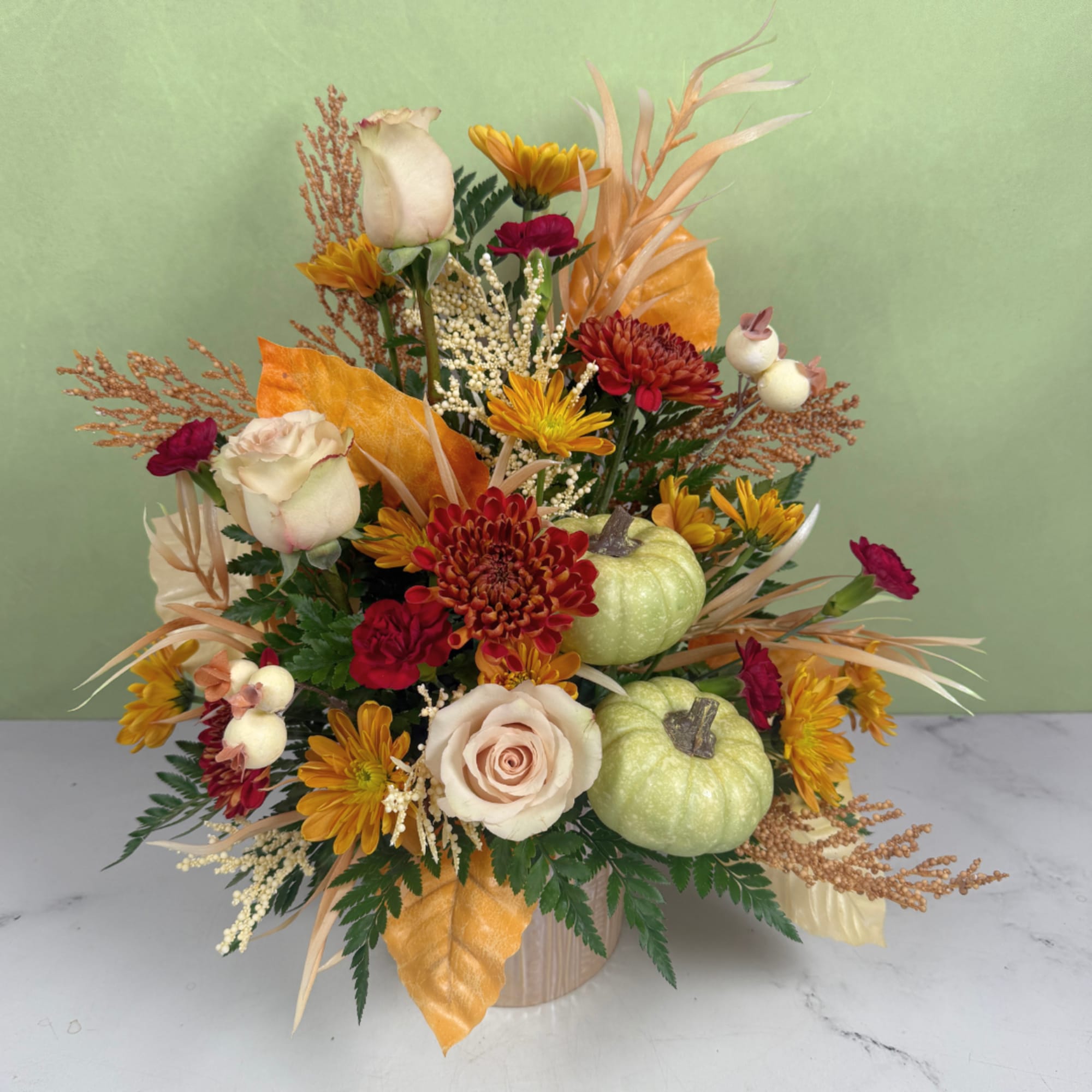 Autumn floral arrangement with roses, chrysanthemums, and small pumpkins in a vase, photo 3 of 3
