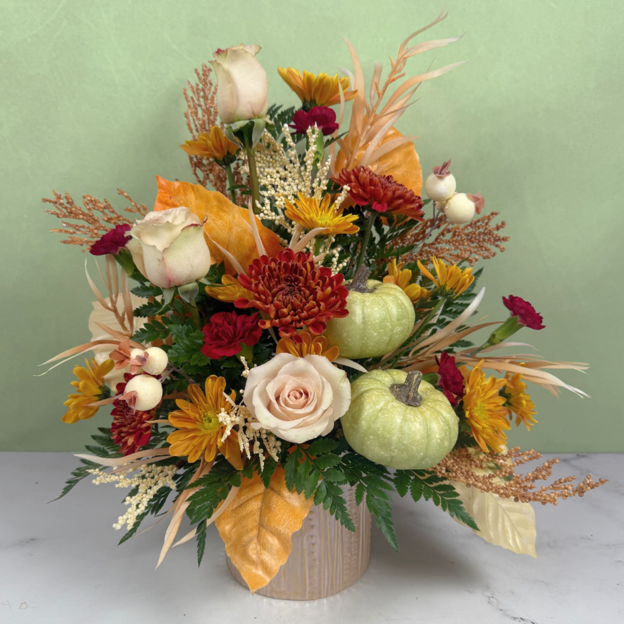 Autumn floral arrangement with roses, chrysanthemums, and small pumpkins in a vase, photo 2 of 3