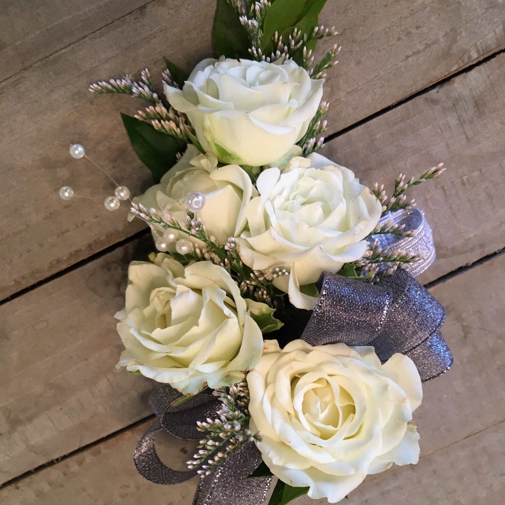 White rose bouquet with silver ribbon and pearl accents
