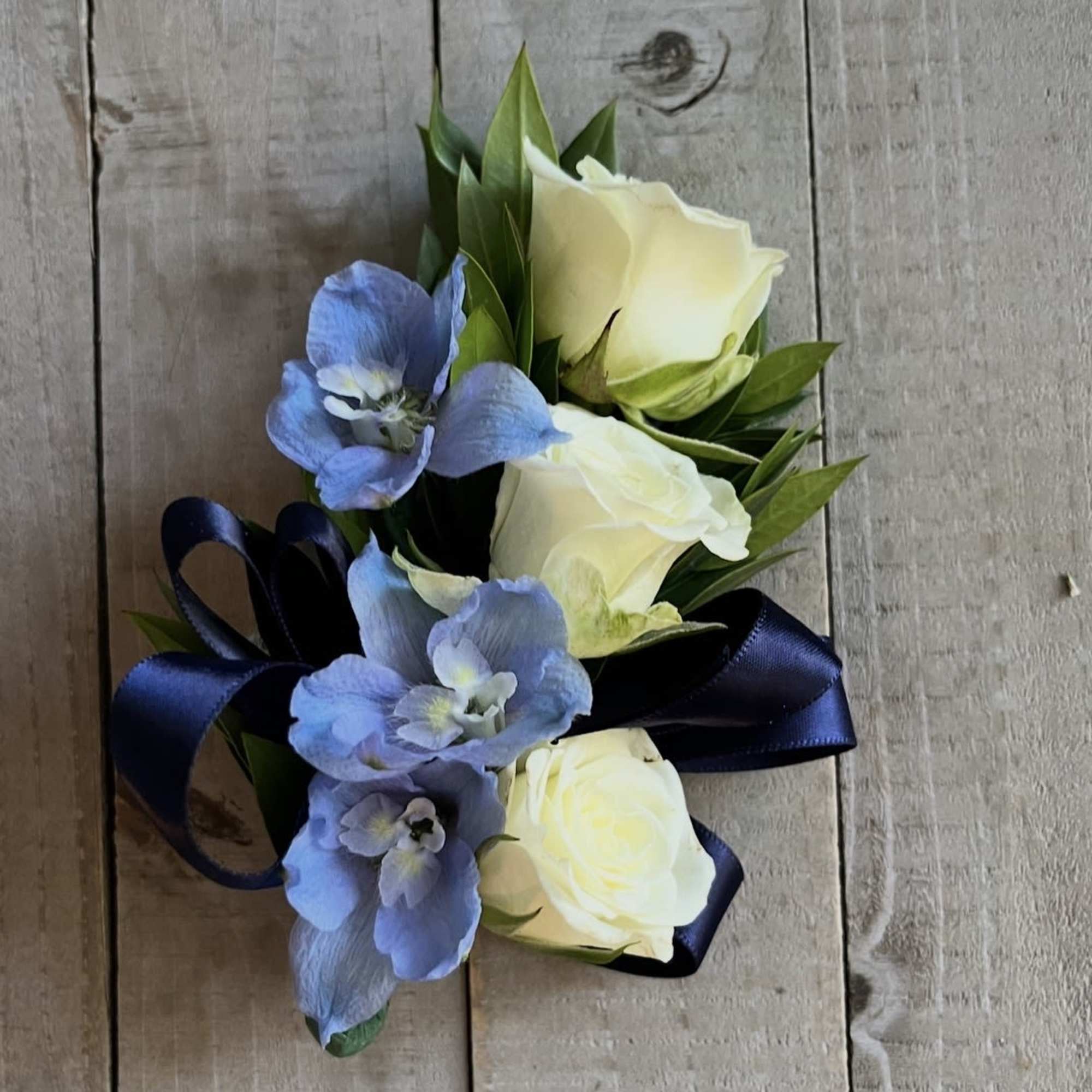 WHITE SPRAY ROSE Wristlet corsages, accent flowers, greens and ivory ribbon. 