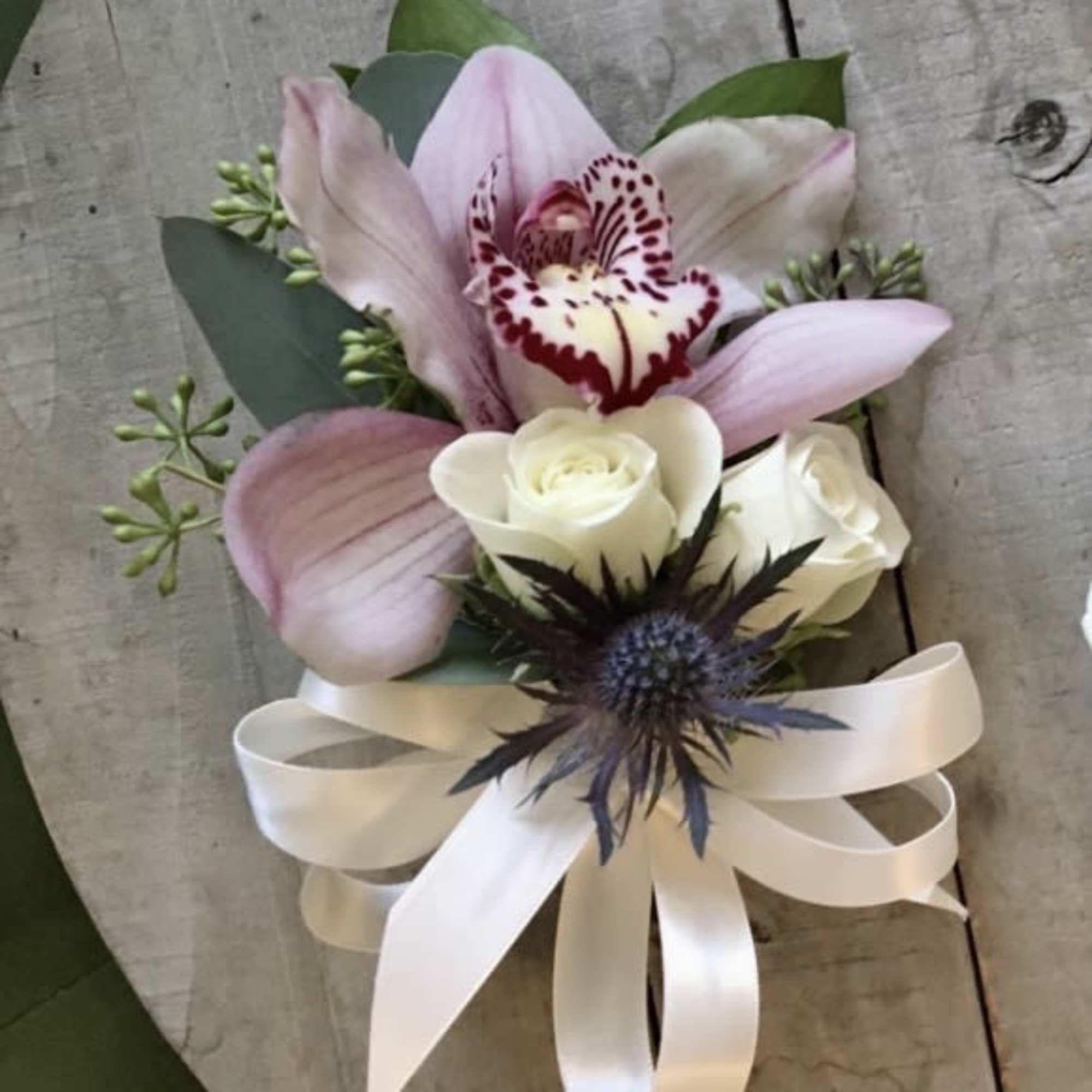 WHITE SPRAY ROSE Wristlet corsages, accent flowers, greens and ivory ribbon. 