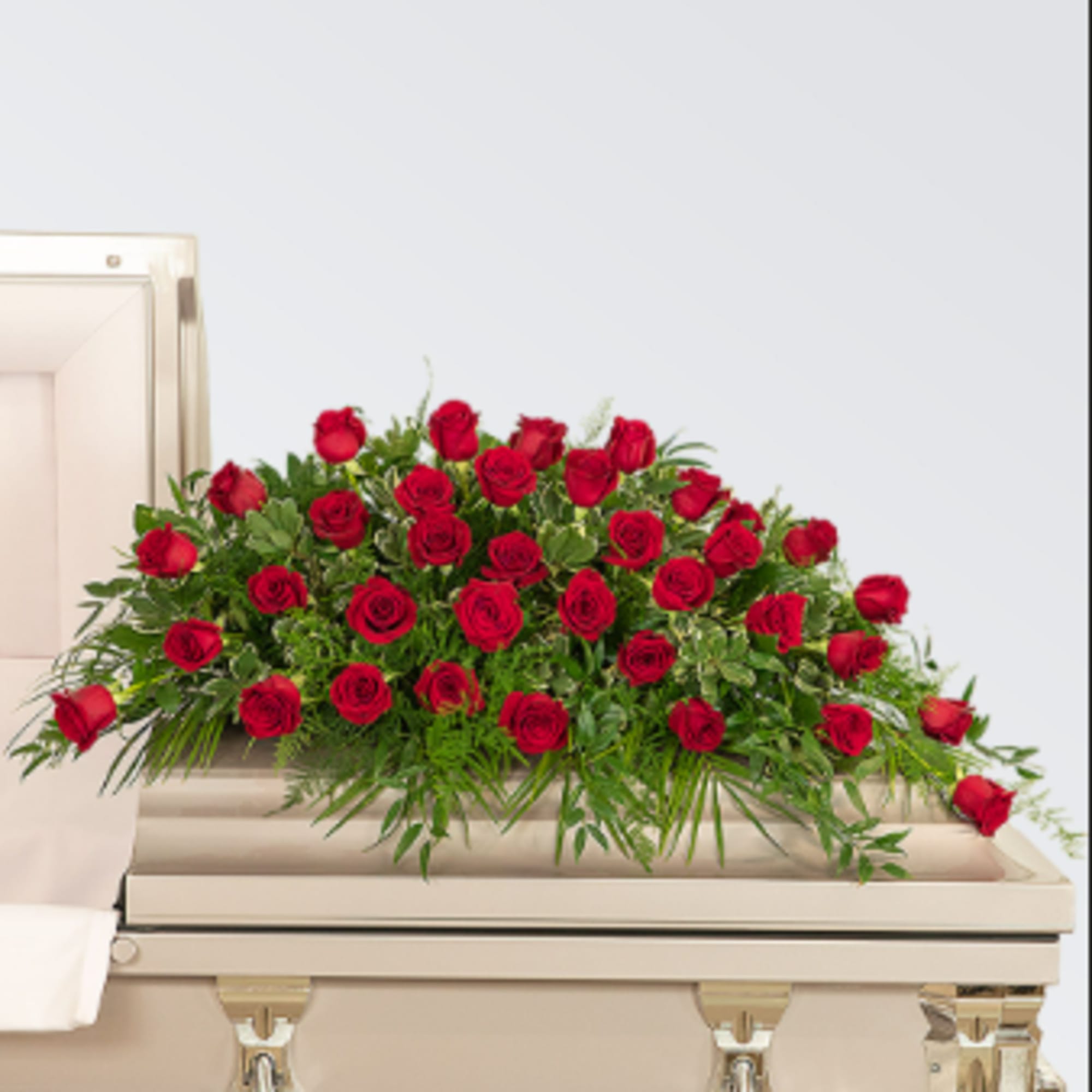 A dense spray of deep red roses laid across the top of