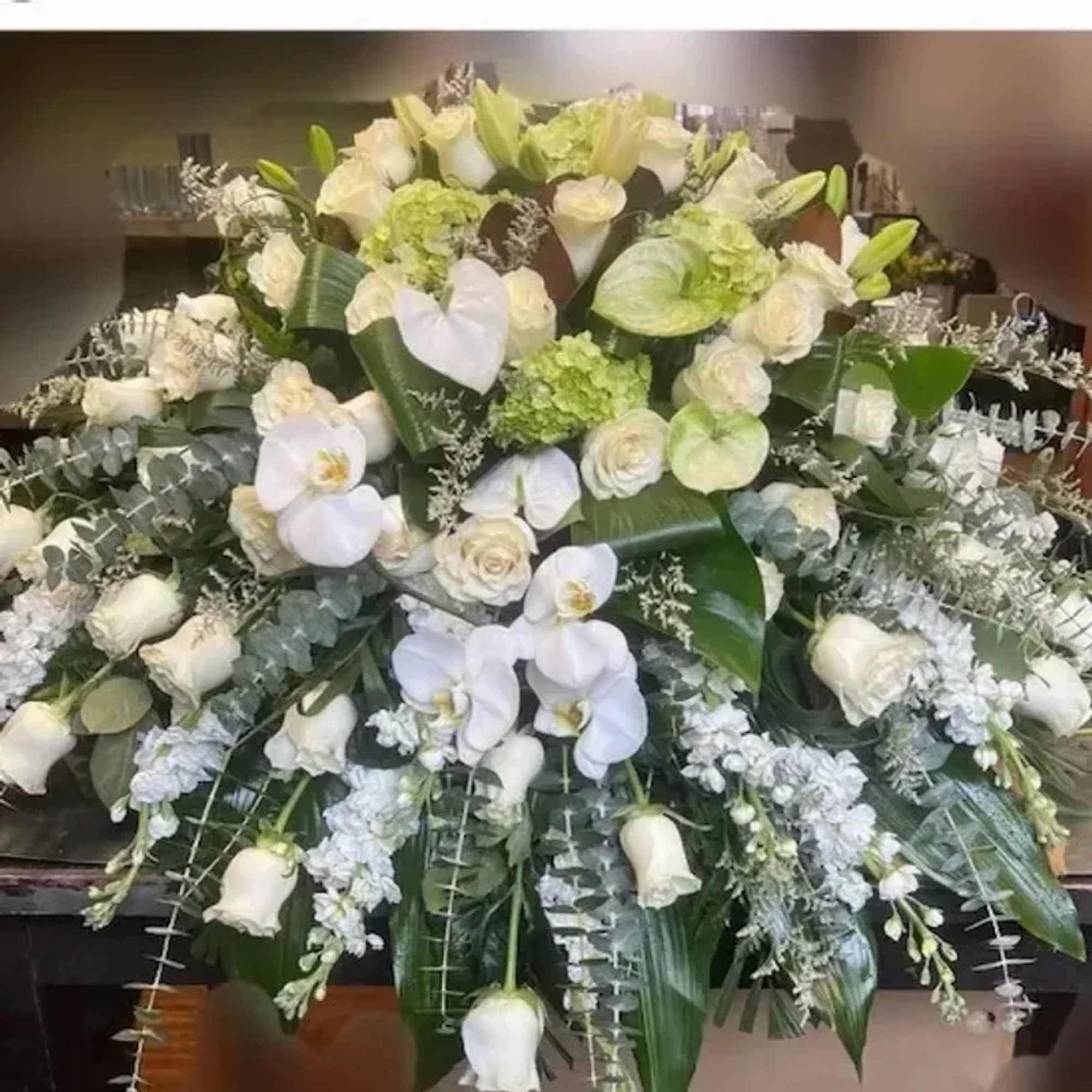 Cascading white Phalaenopsis orchids and full-headed hydrangeas form the first impression-an elegant