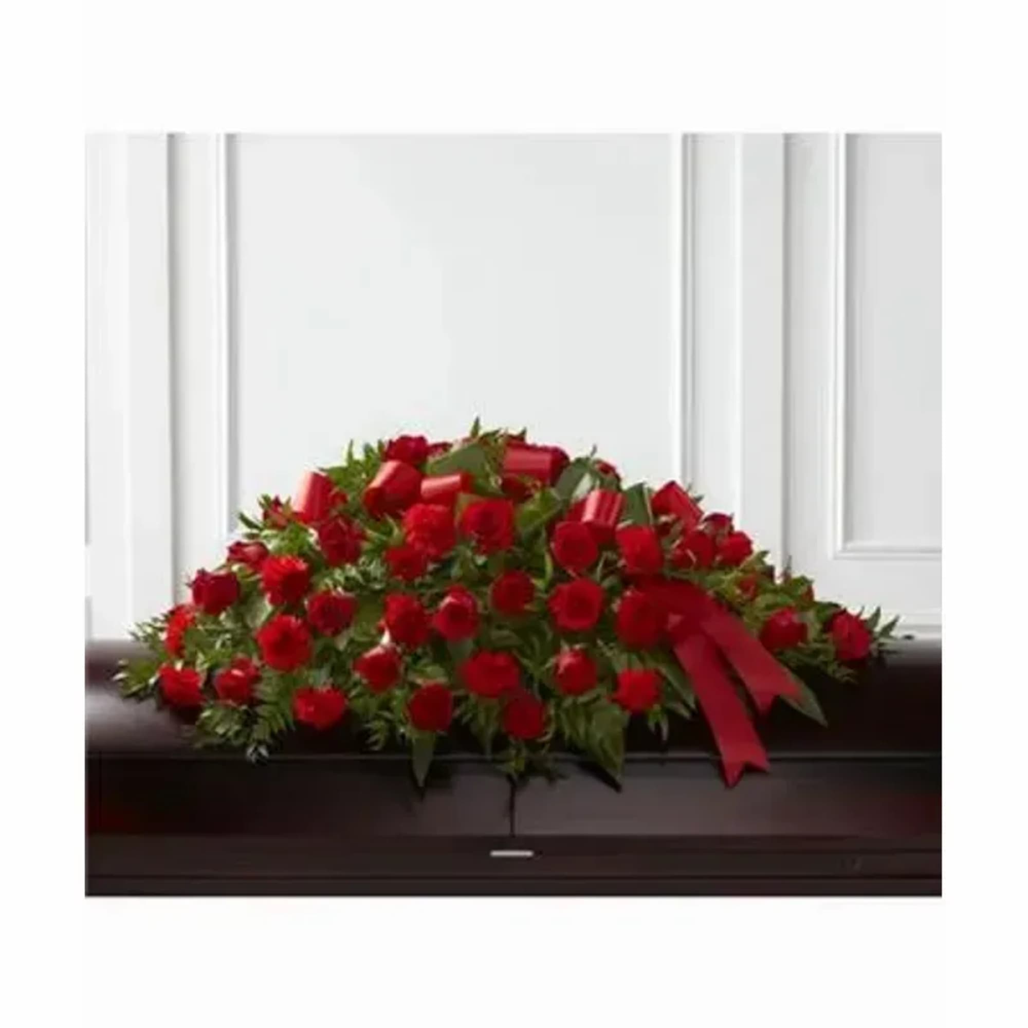 A dense dome of deep red roses creates a solemn, dignified statement