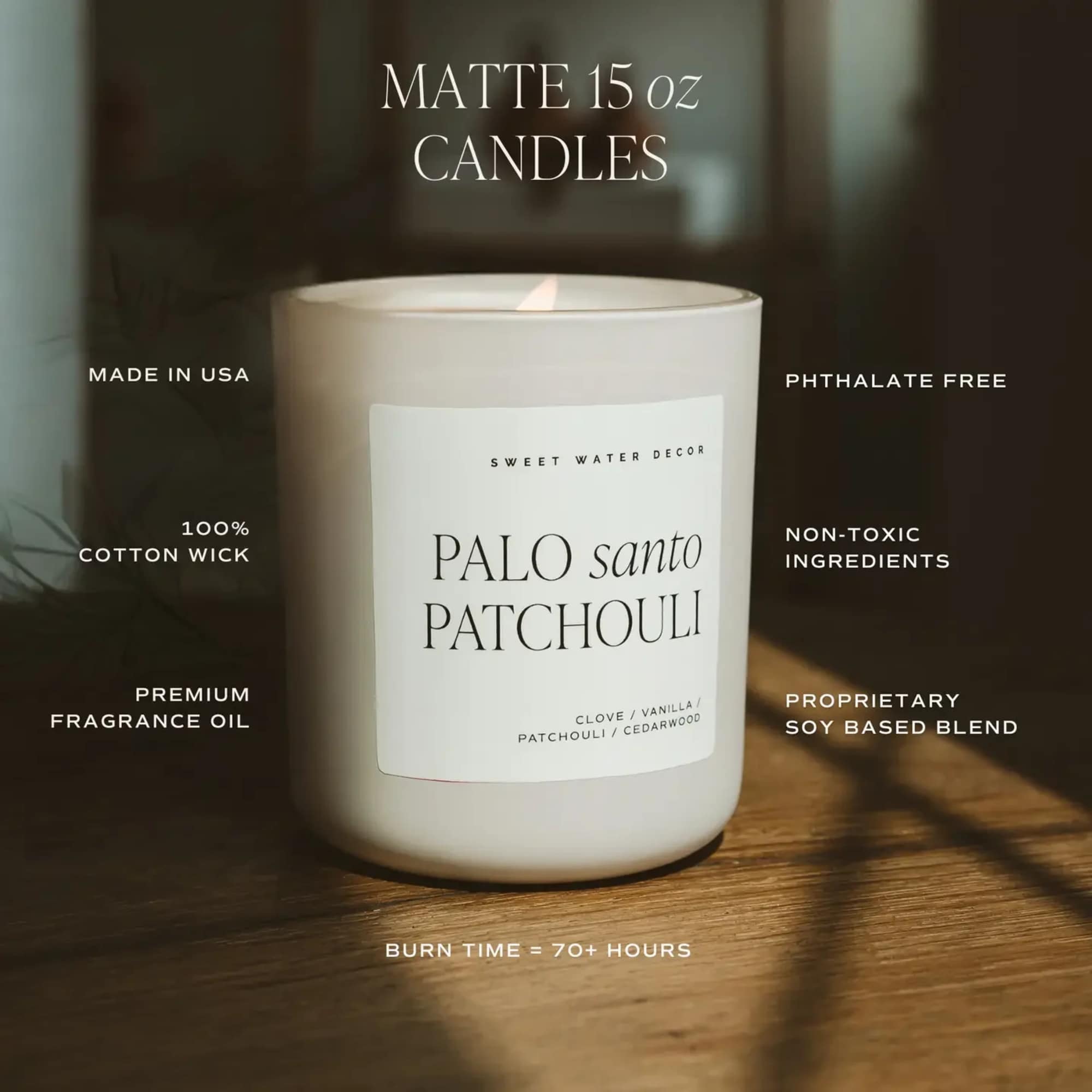White scented candle in a glass jar on a wooden surface