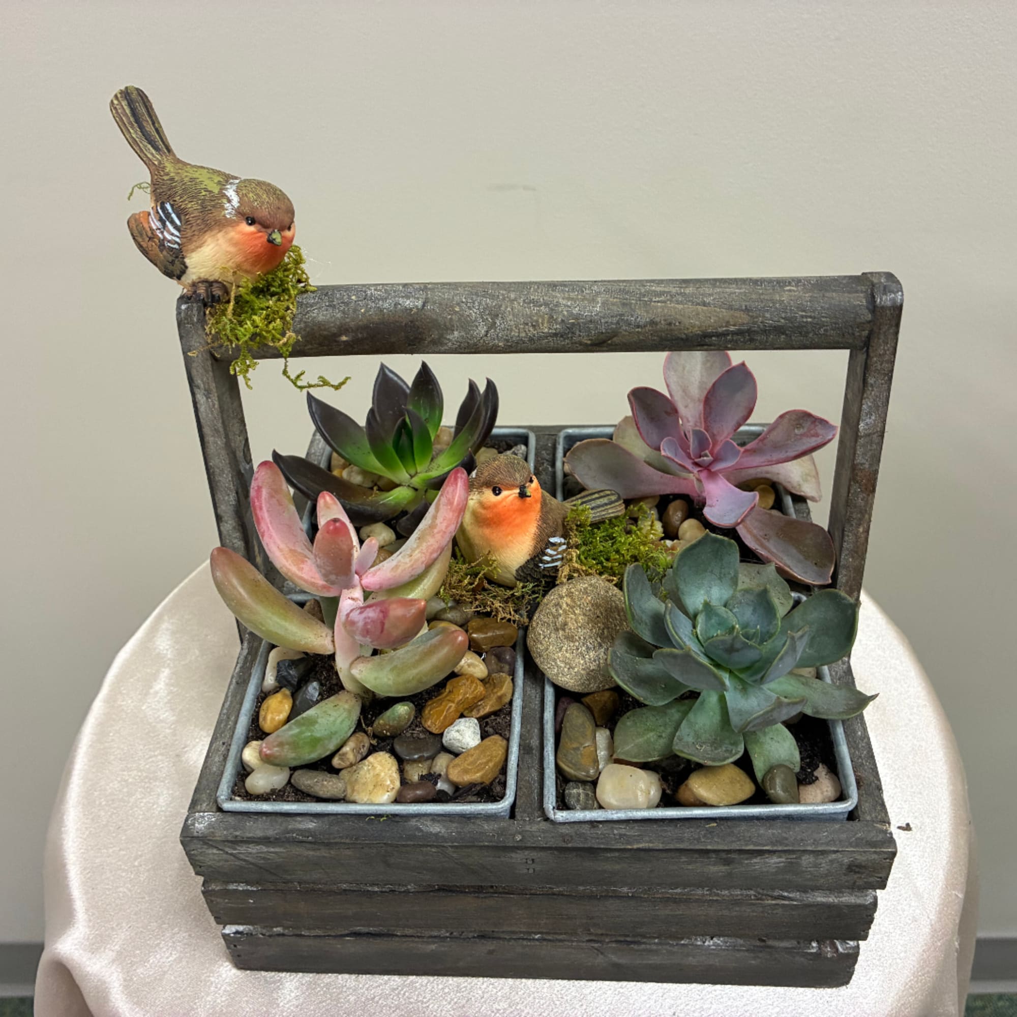Succulent planter in a wooden box with two bird figurines