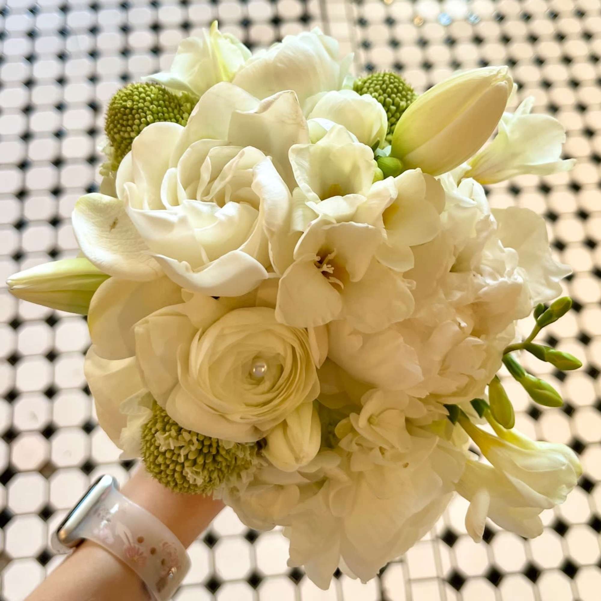 White bouquet with tulips, roses, and hydrangea-like blooms