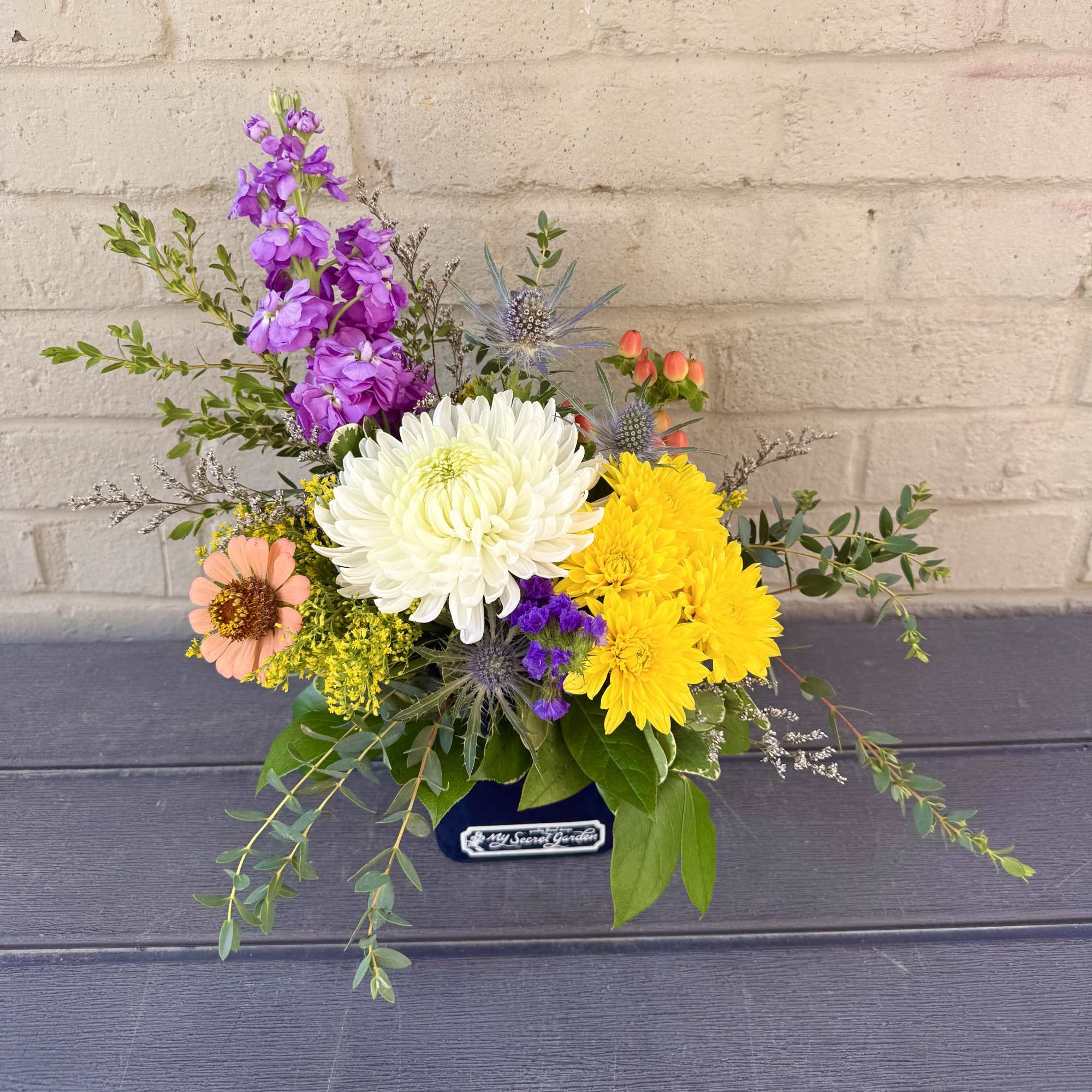 "Brilliant Blossoms" is a beautiful and petite floral design of vibrant flowers
