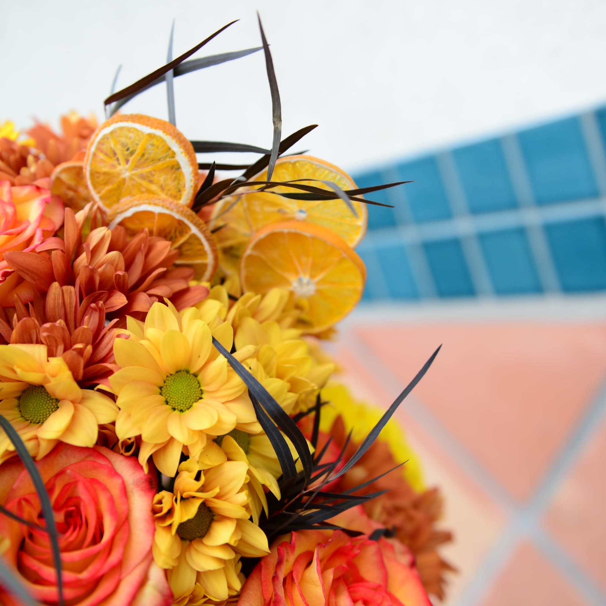 Bouquet of orange and yellow flowers with dried citrus slices