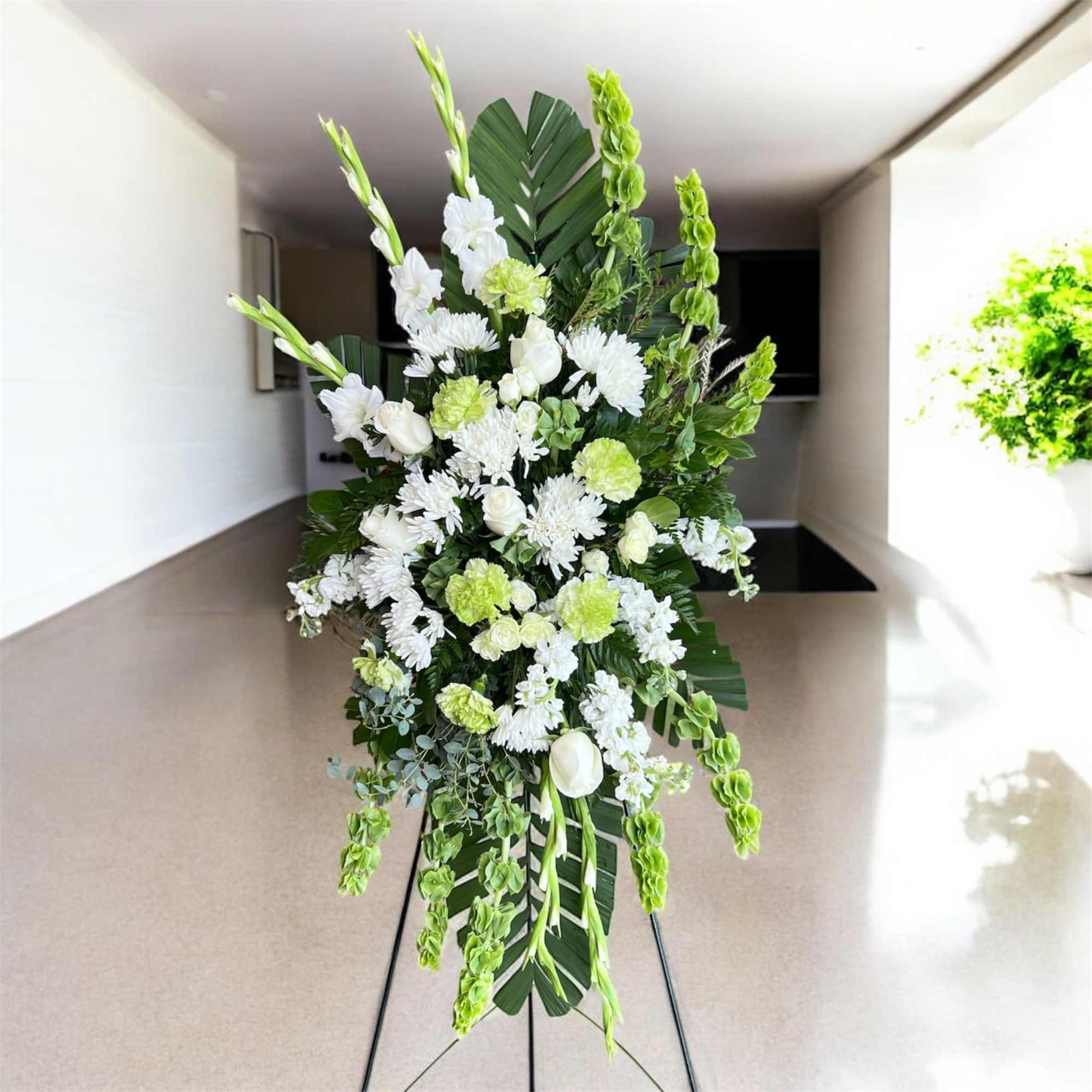 Tall white and green floral standing spray on an easel, photo 2 of 2
