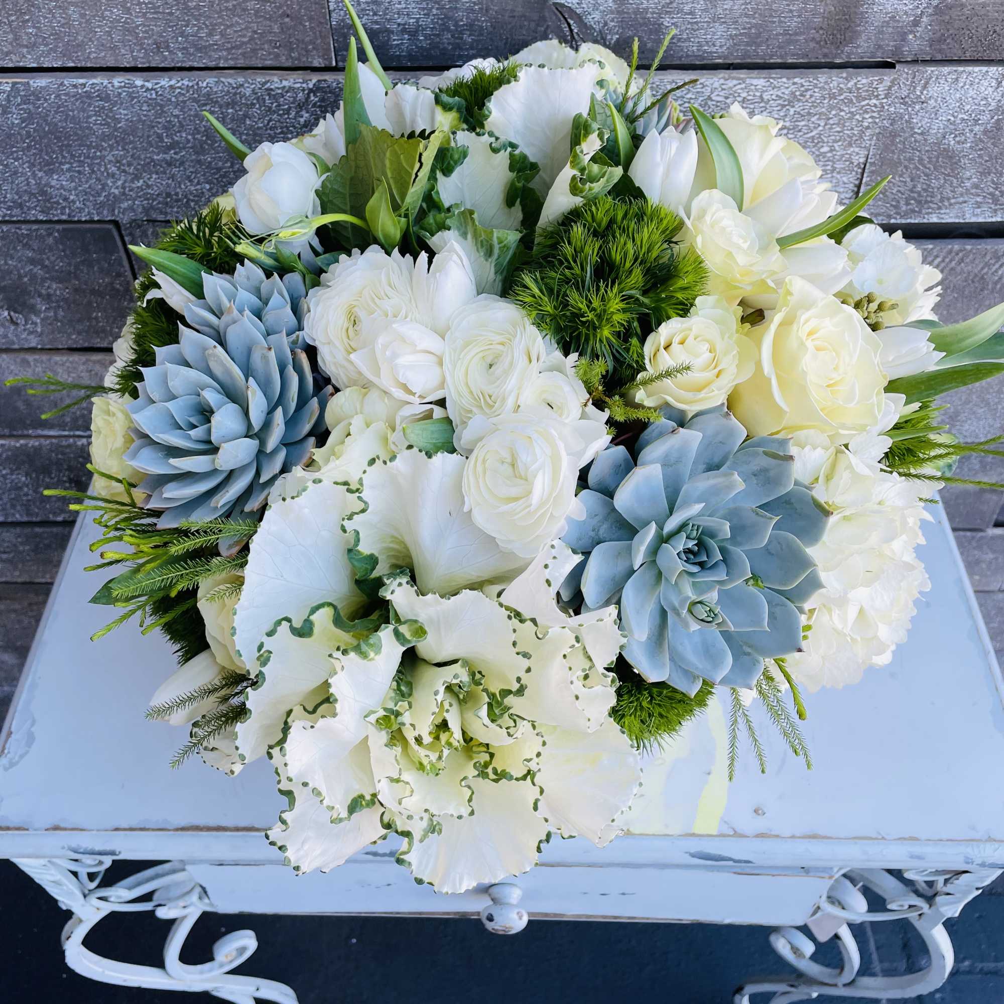 White and blue floral bouquet with succulents and roses
