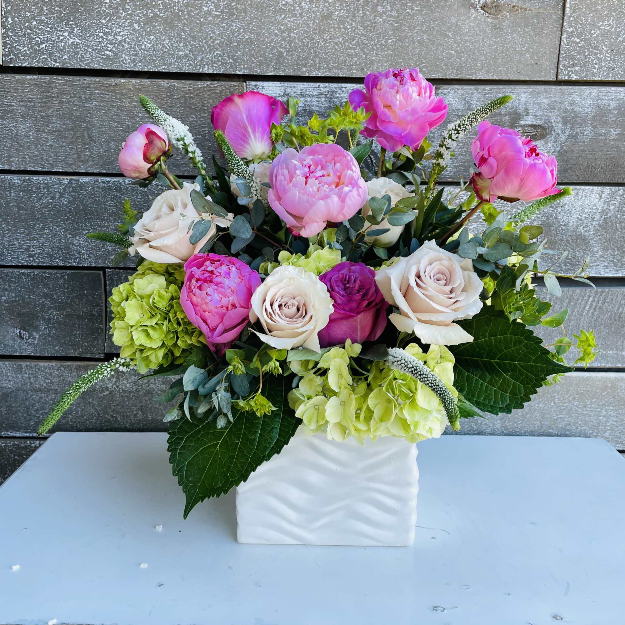 Pink peonies and roses arranged in a white vase, photo 3 of 4