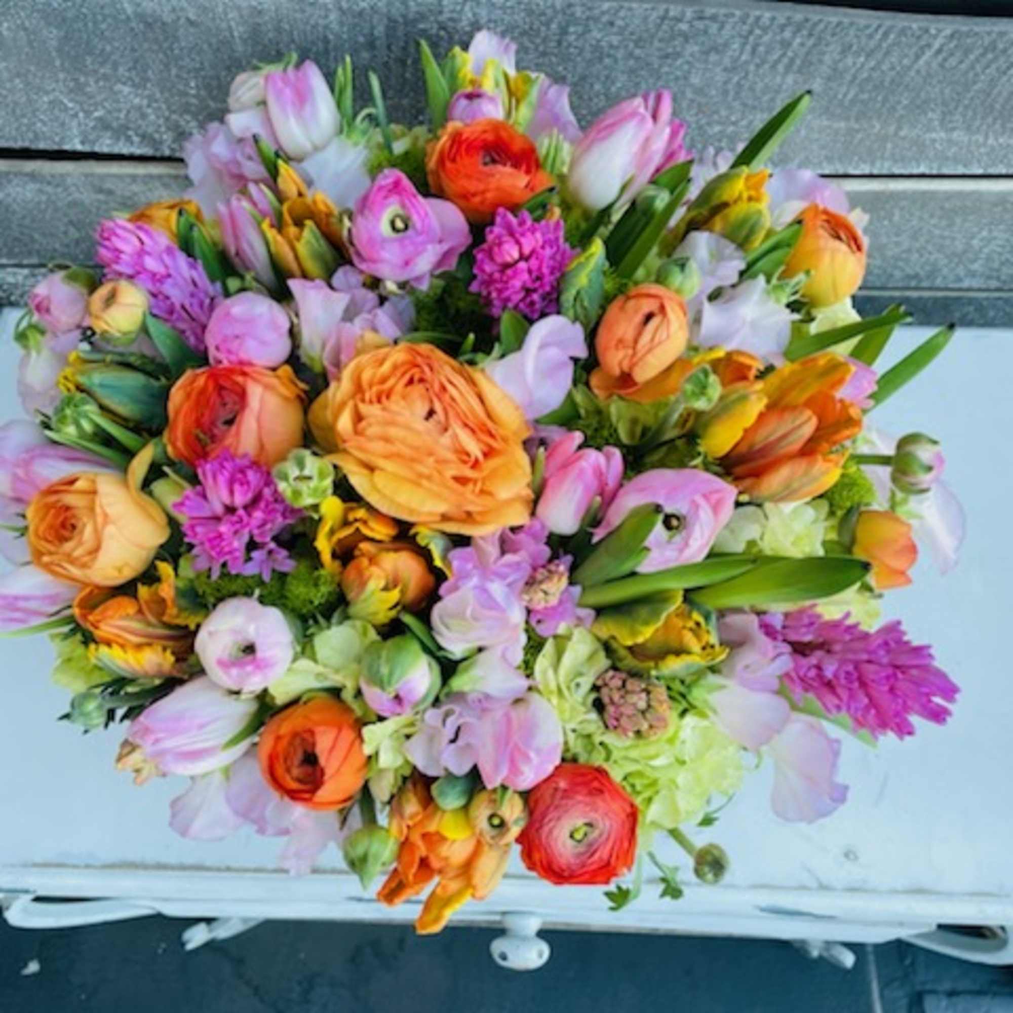 Colorful bouquet of mixed flowers with orange, pink, and lavender blooms