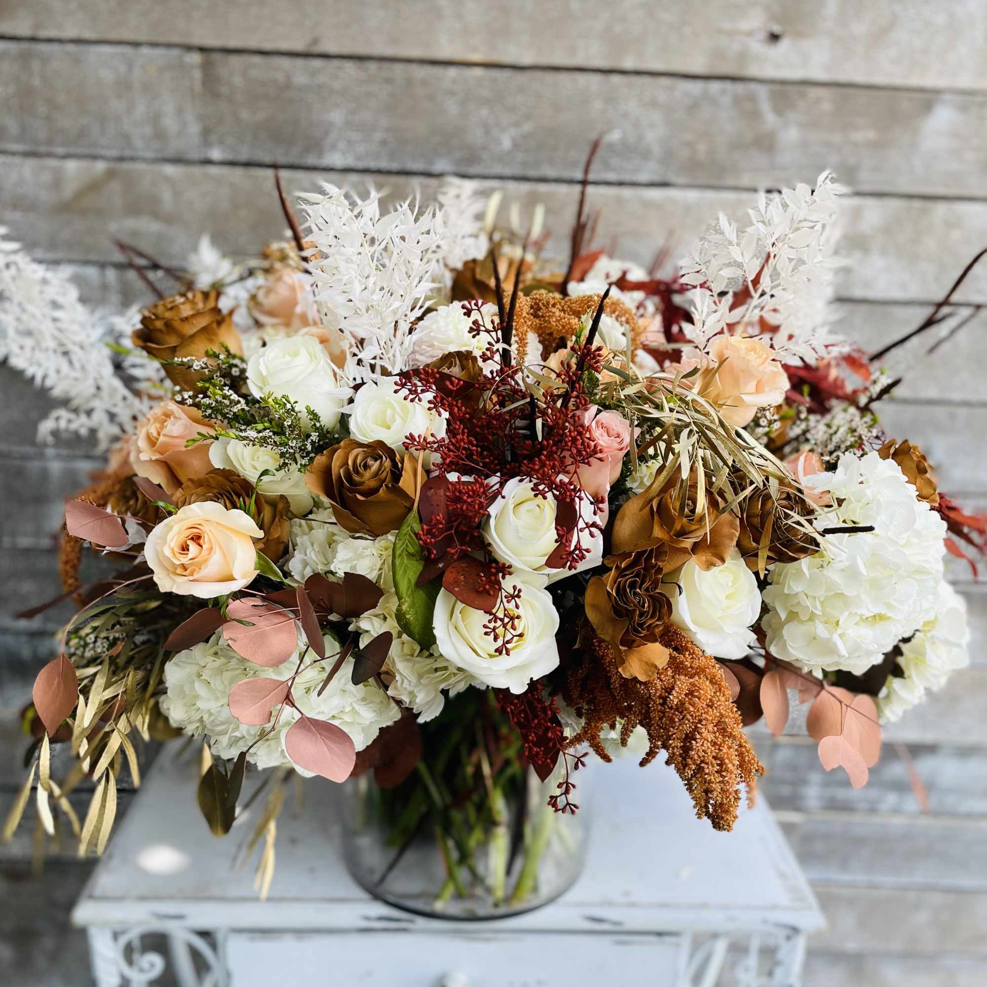 Bouquet of cream and peach roses in a glass vase