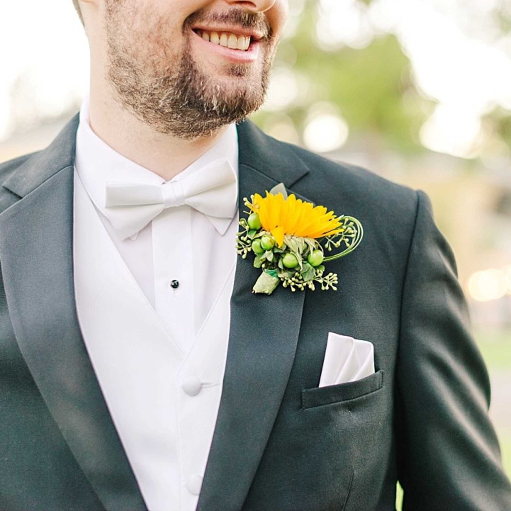 Man in a suit wearing a yellow boutonniere