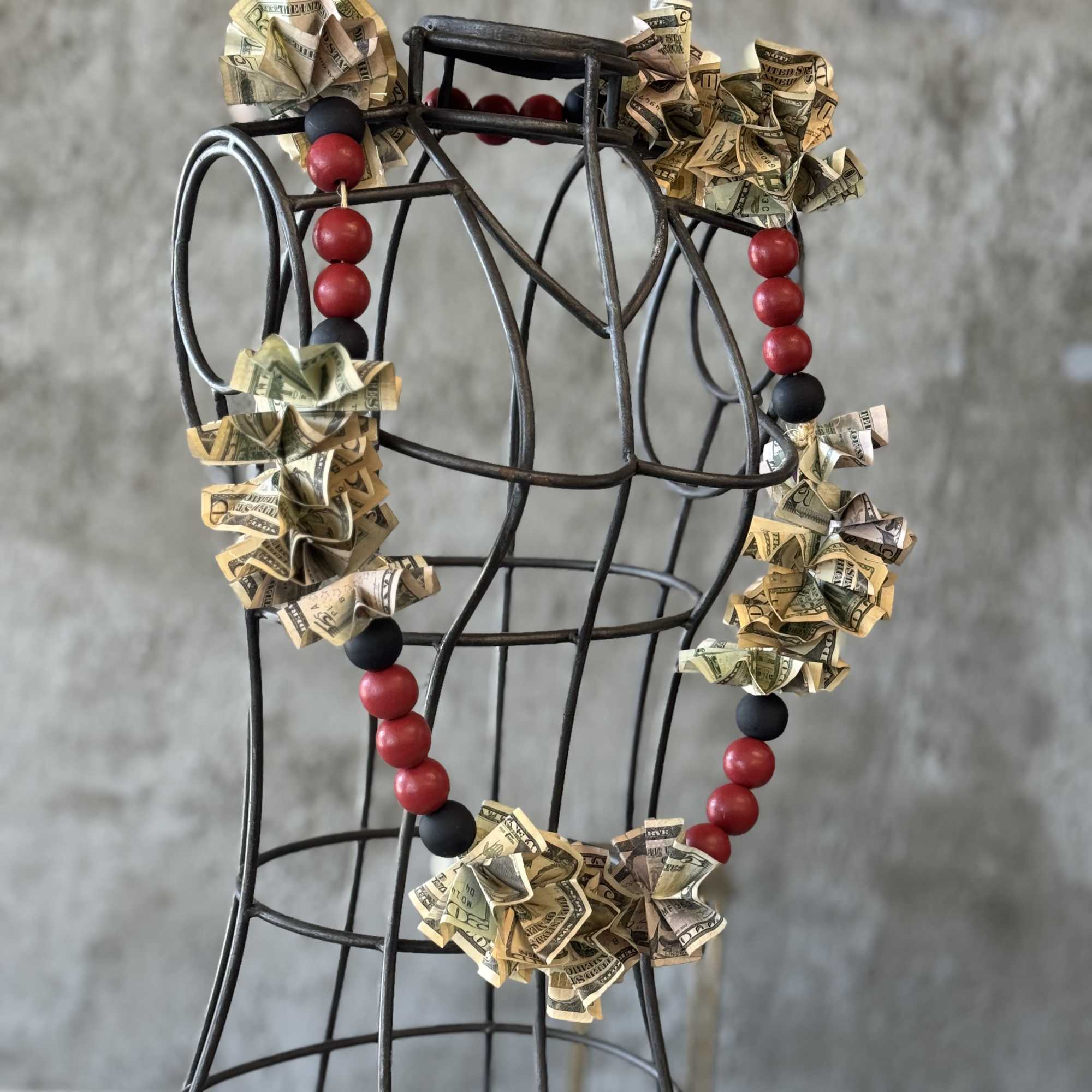Money lei draped over a wire dress form, photo 5 of 5