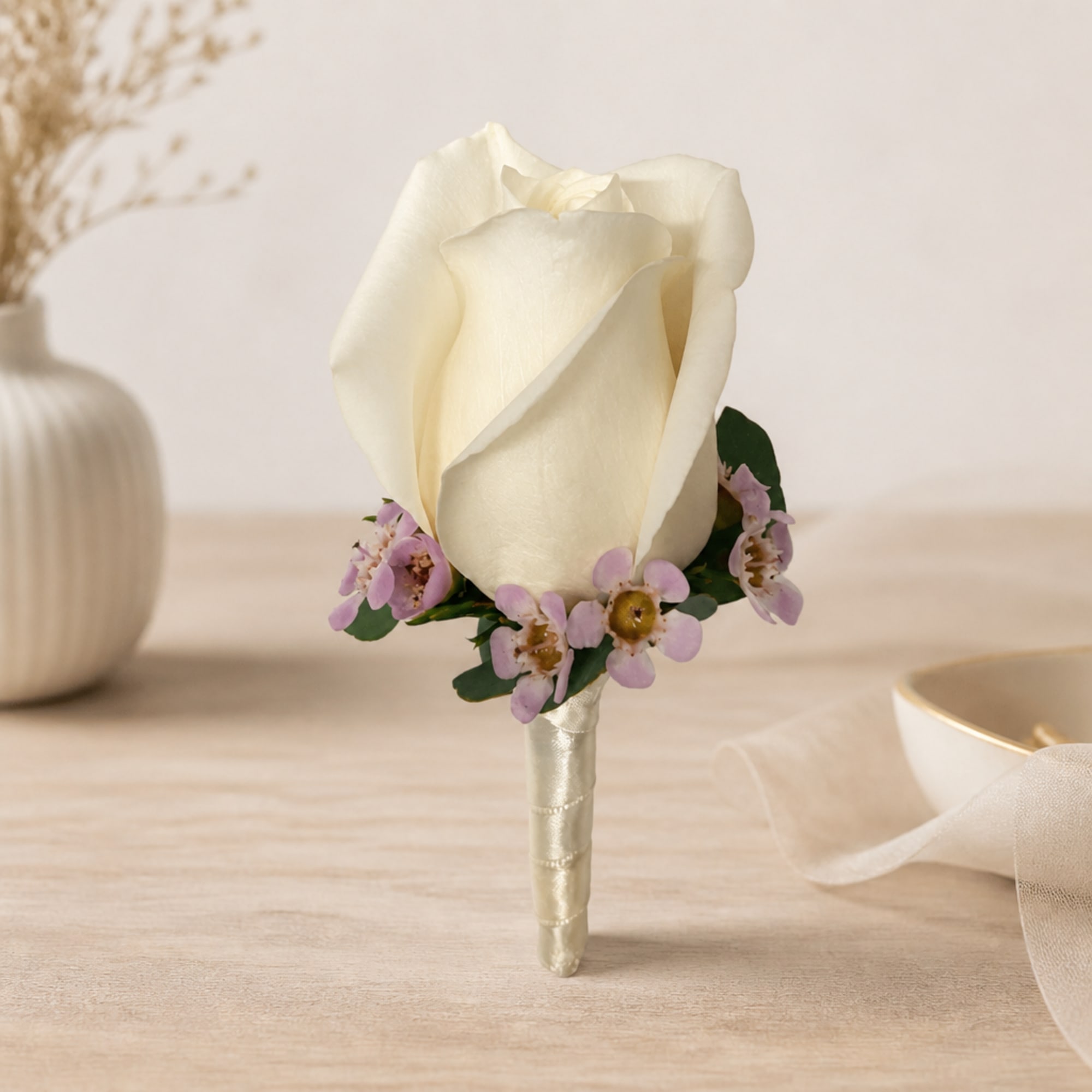 White rose boutonniere with small lavender flowers