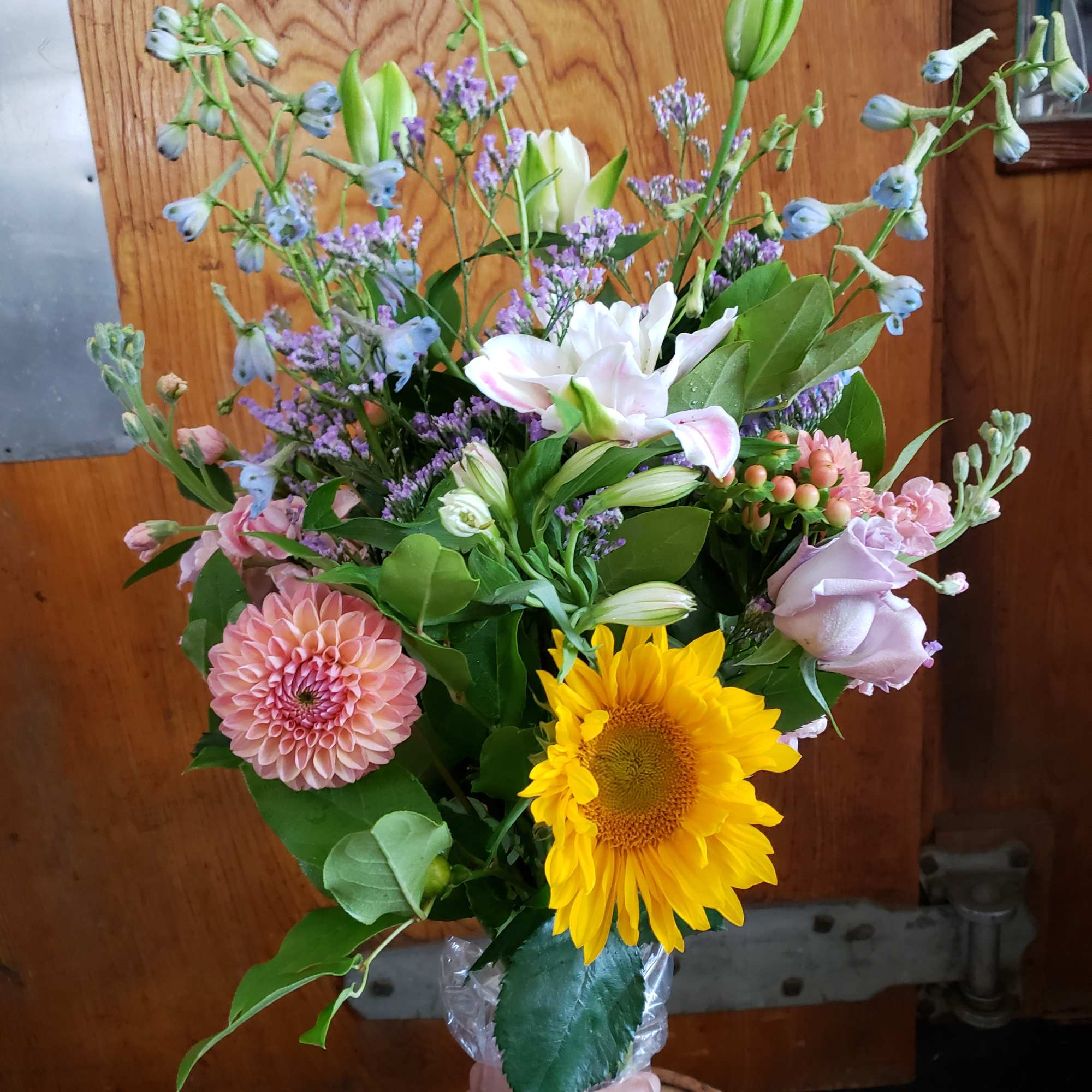 Mixed bouquet with sunflower, dahlia, lilies, and pastel blooms