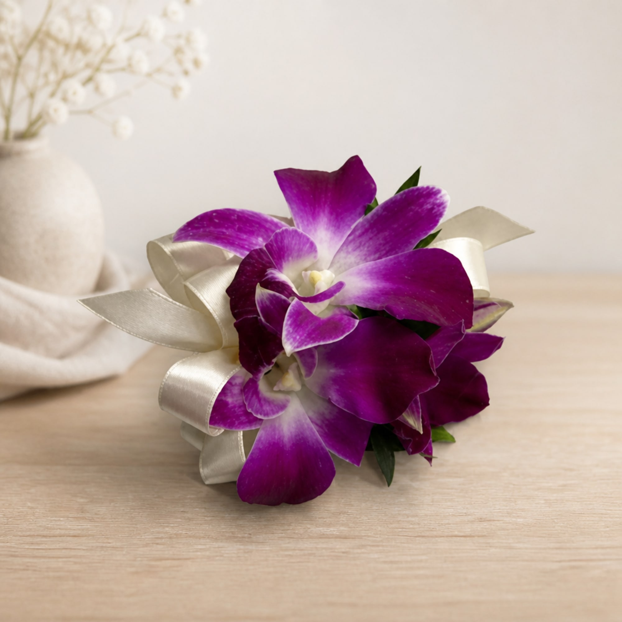 Purple orchid corsage with a satin ribbon bow