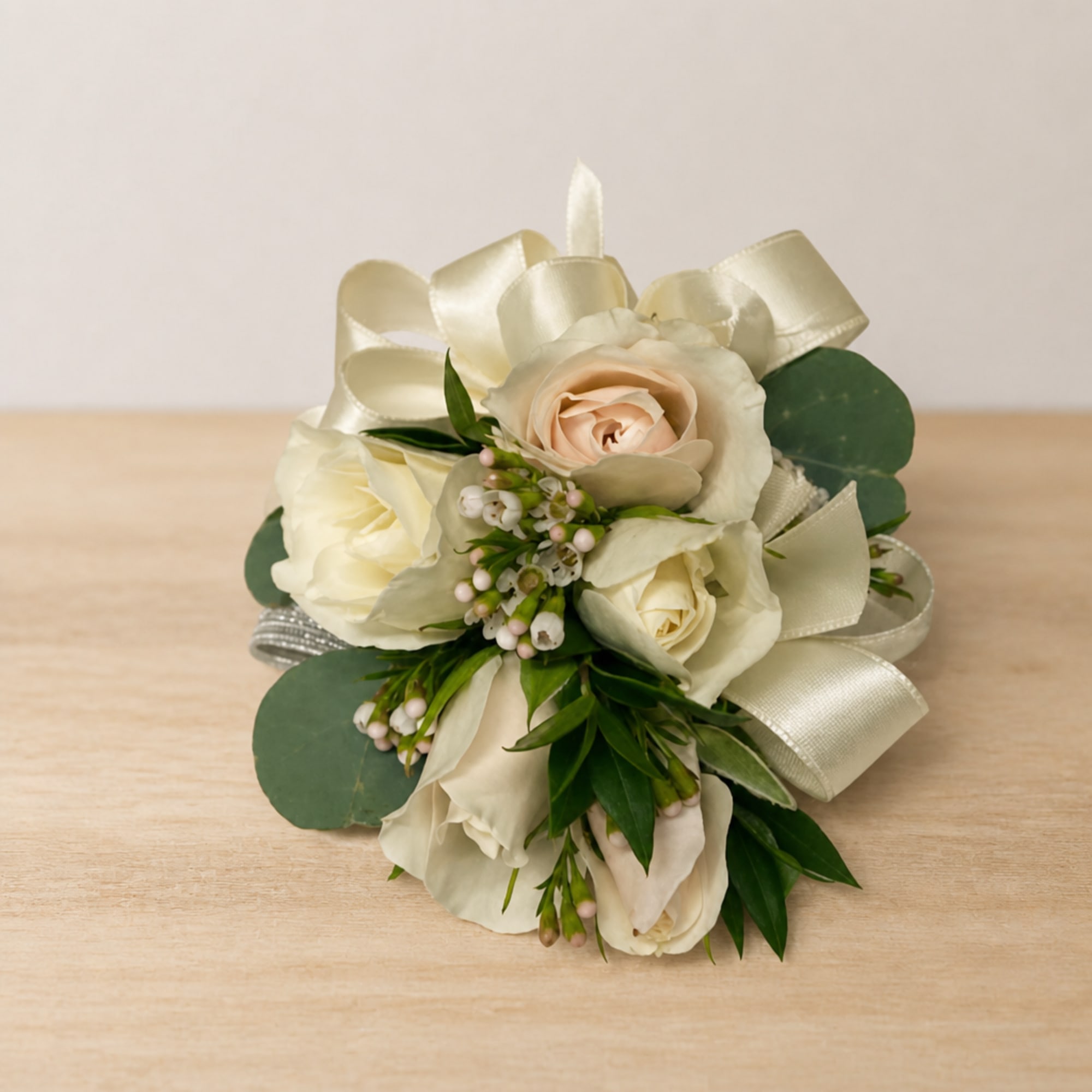 Cream rose bridal bouquet with ribbon and greenery