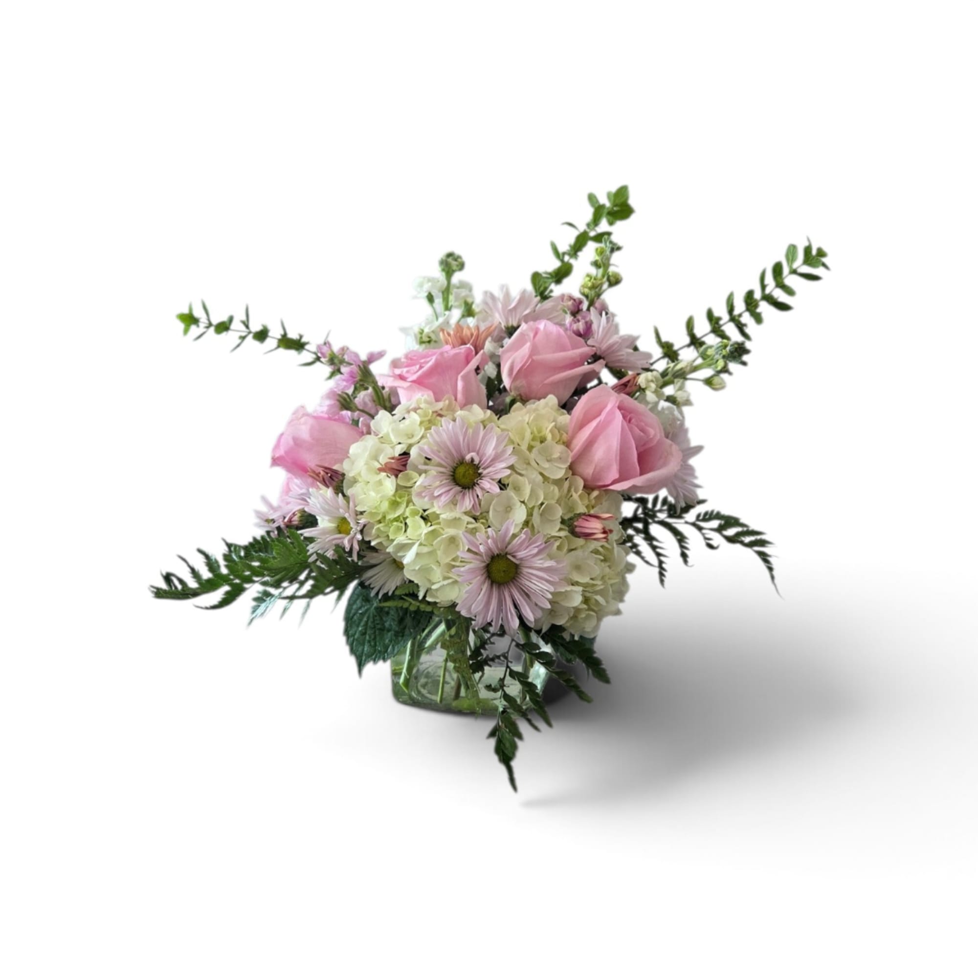 Pink roses and pale daisies in a glass vase