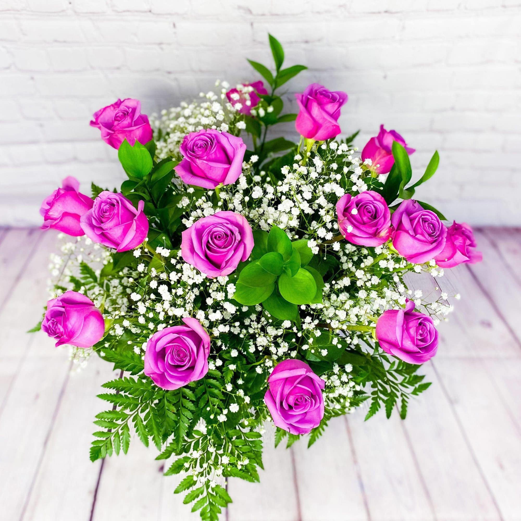 Bouquet of pink roses with white baby's breath and greenery