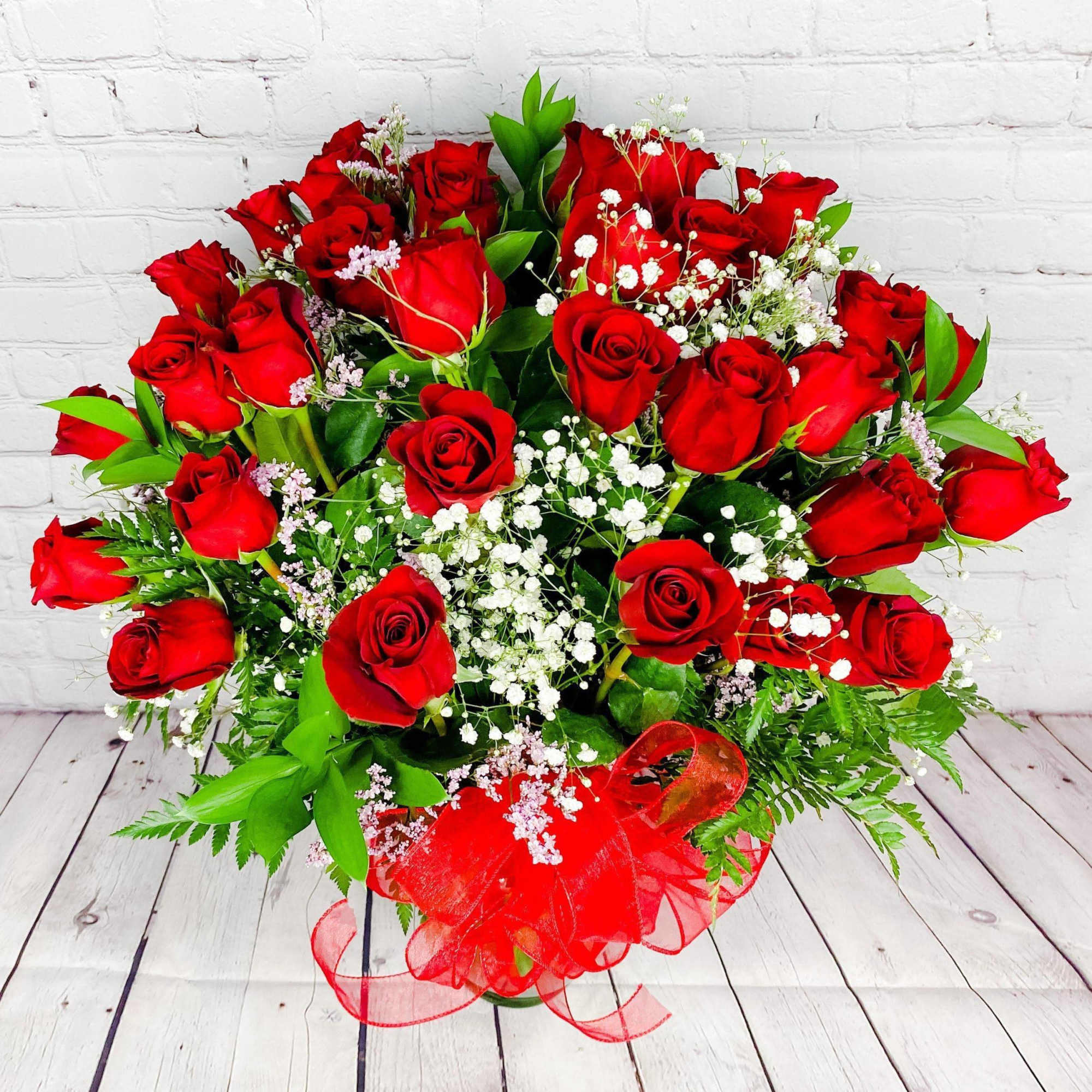 Bouquet of red roses with baby's breath and a red ribbon