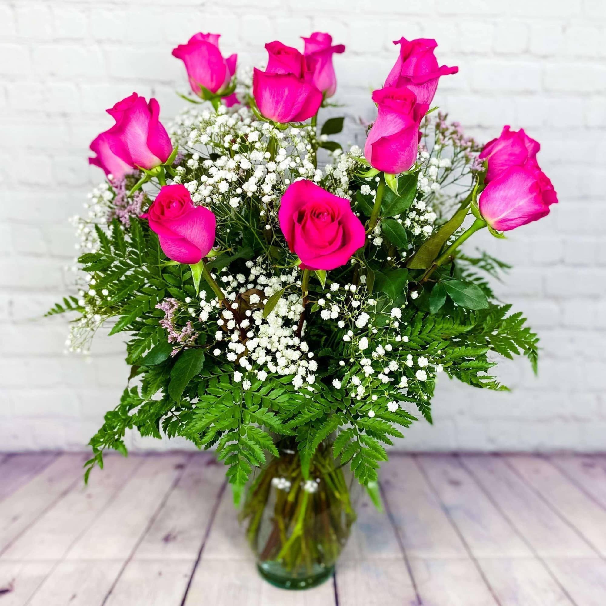 Pink roses and baby's breath in a glass vase