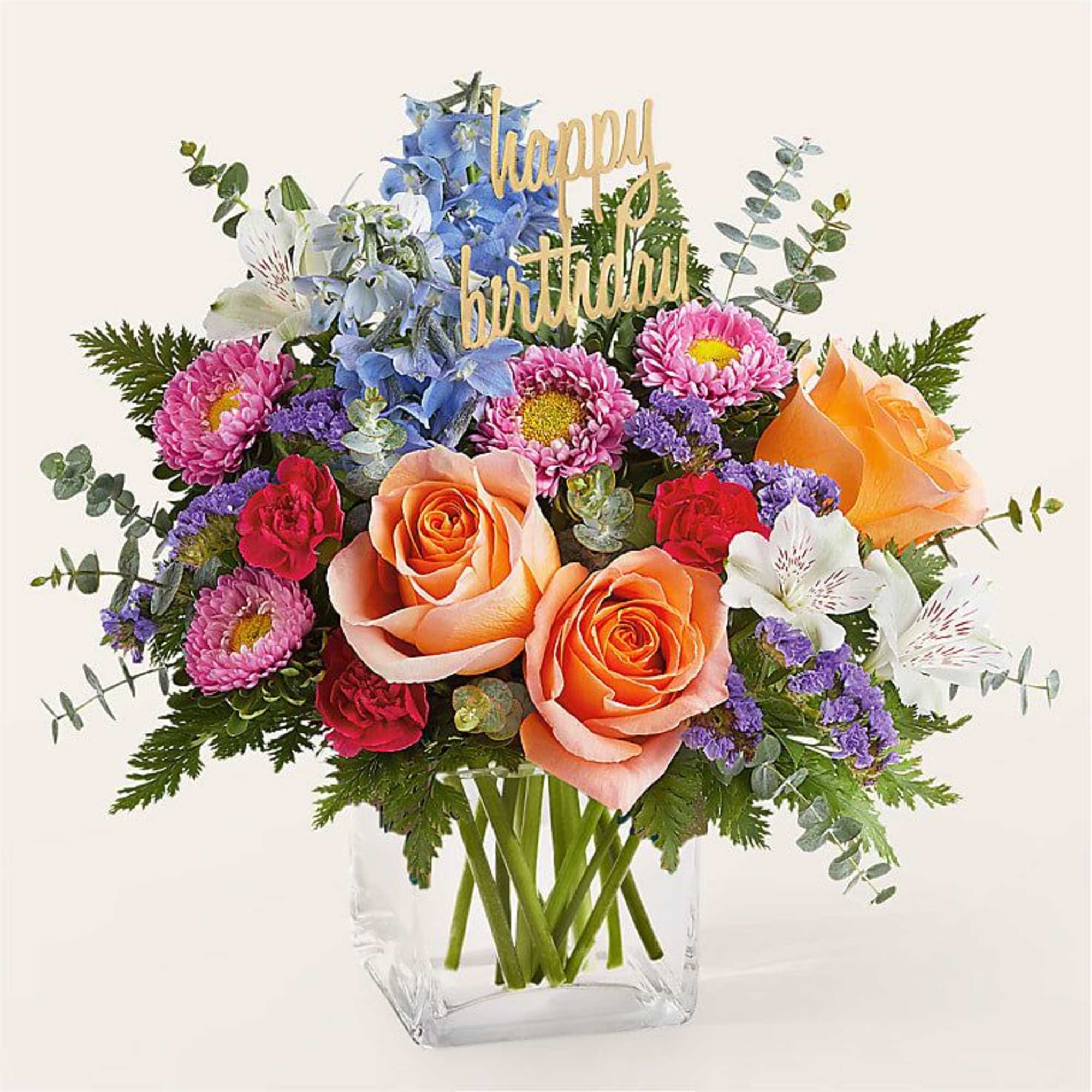 Mixed bouquet in a clear vase with a happy birthday sign